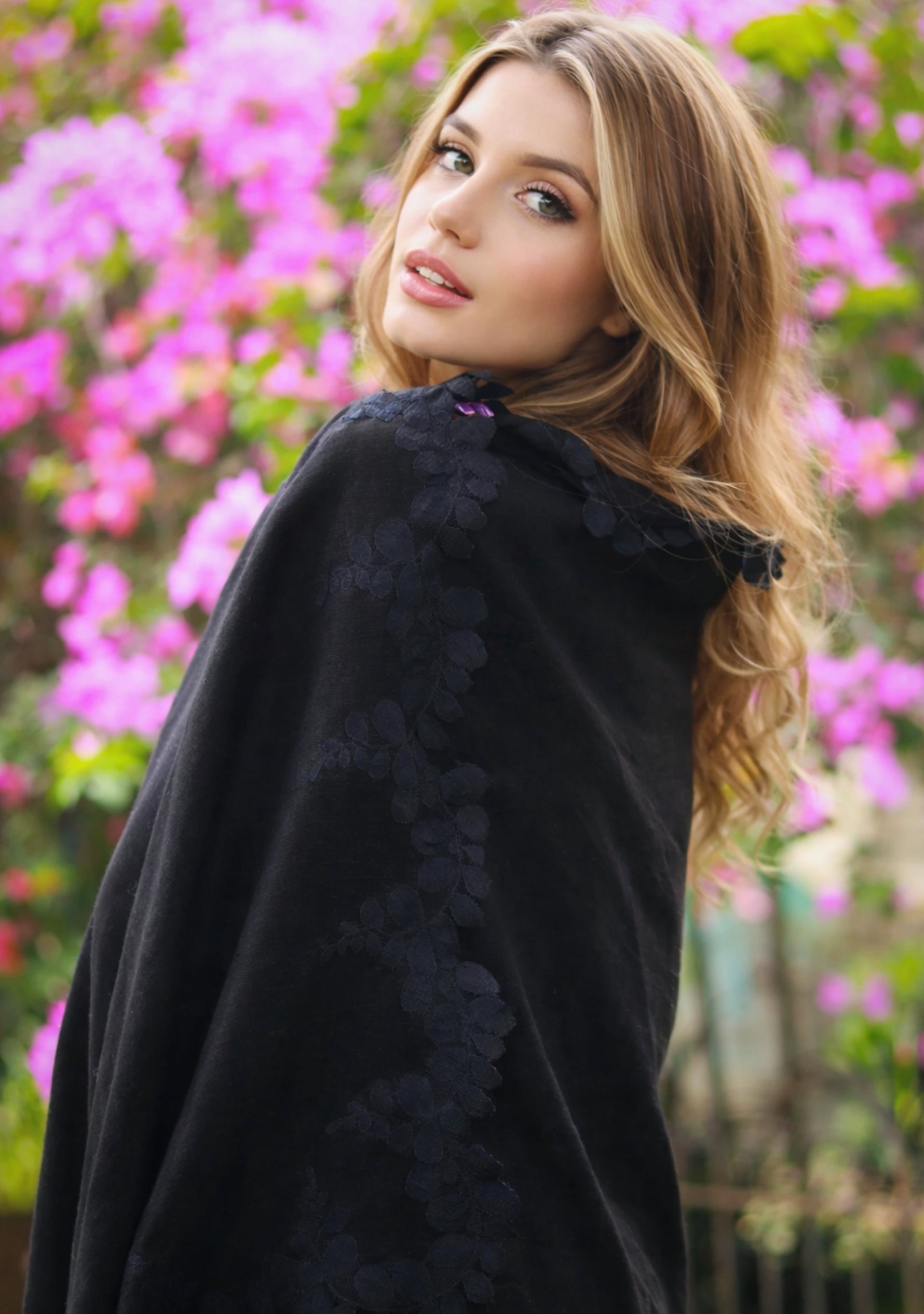 Woman wearing a black floral-scarf floral background