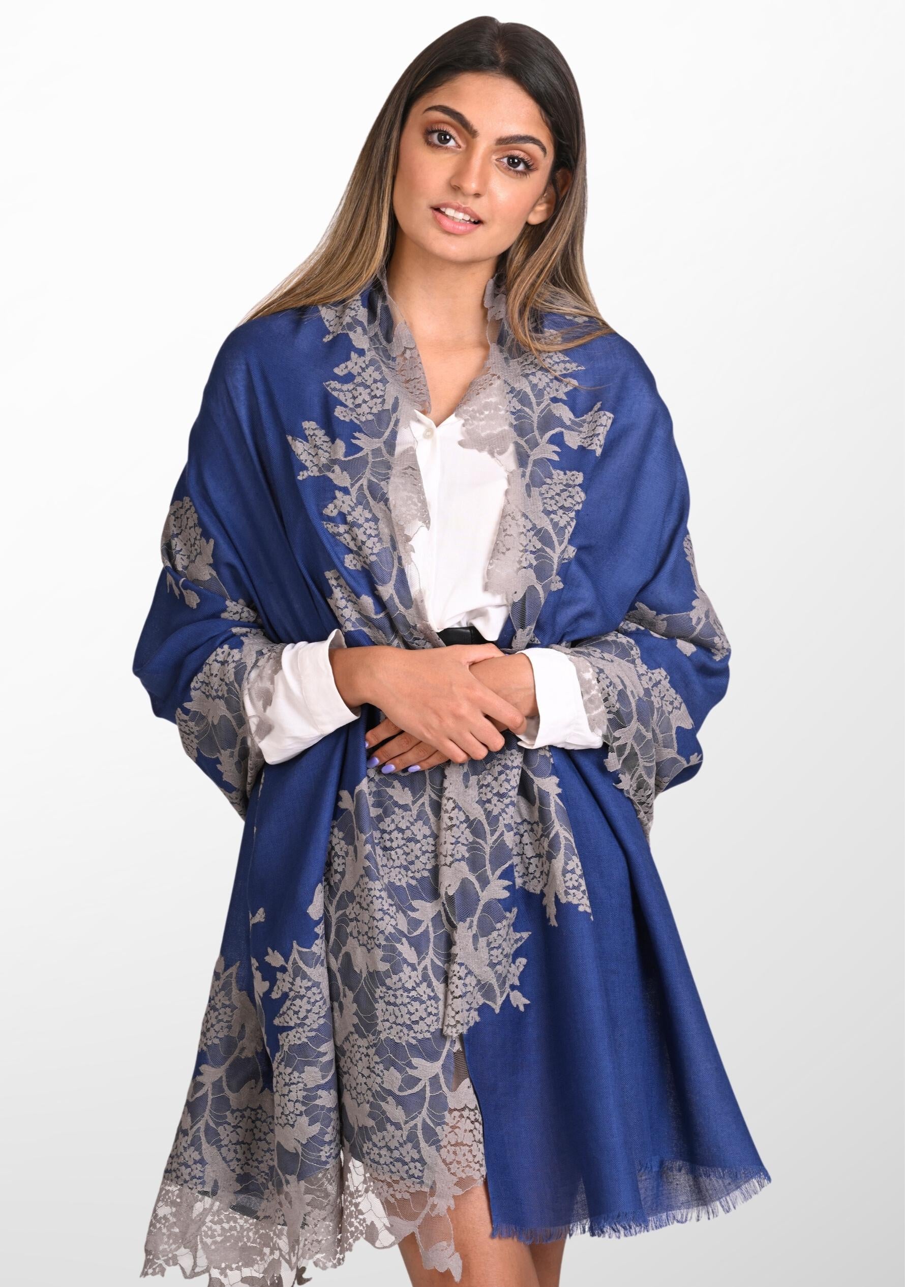 A person wearing a denim blue scarf with mousse lace application