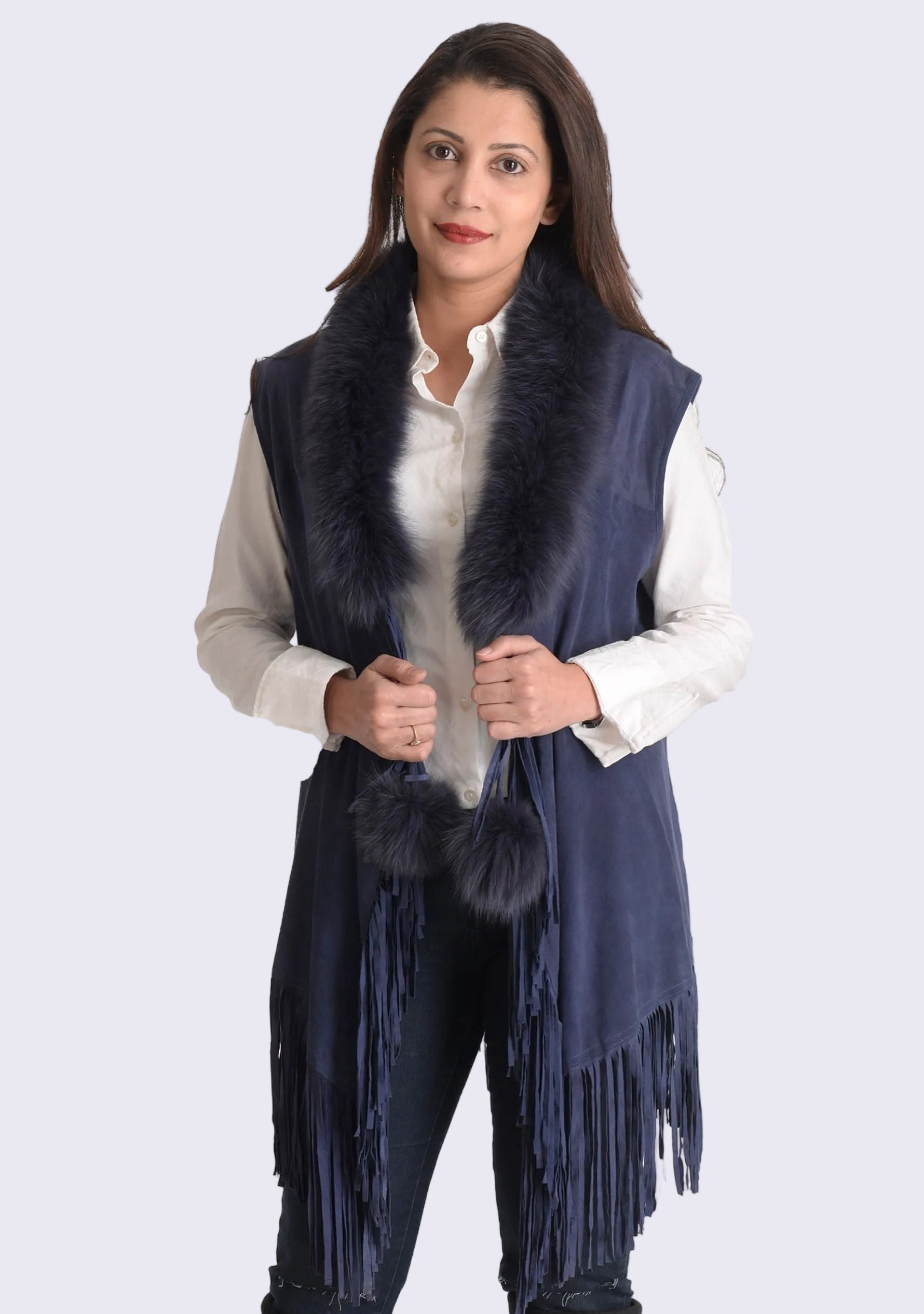 A navy blue suede leather sleeveless jacket with navy blue fur and tan suede leather long tassels, worn by a female model.