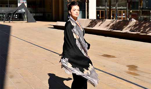 Woman wearing a black scarf with a fall outfit