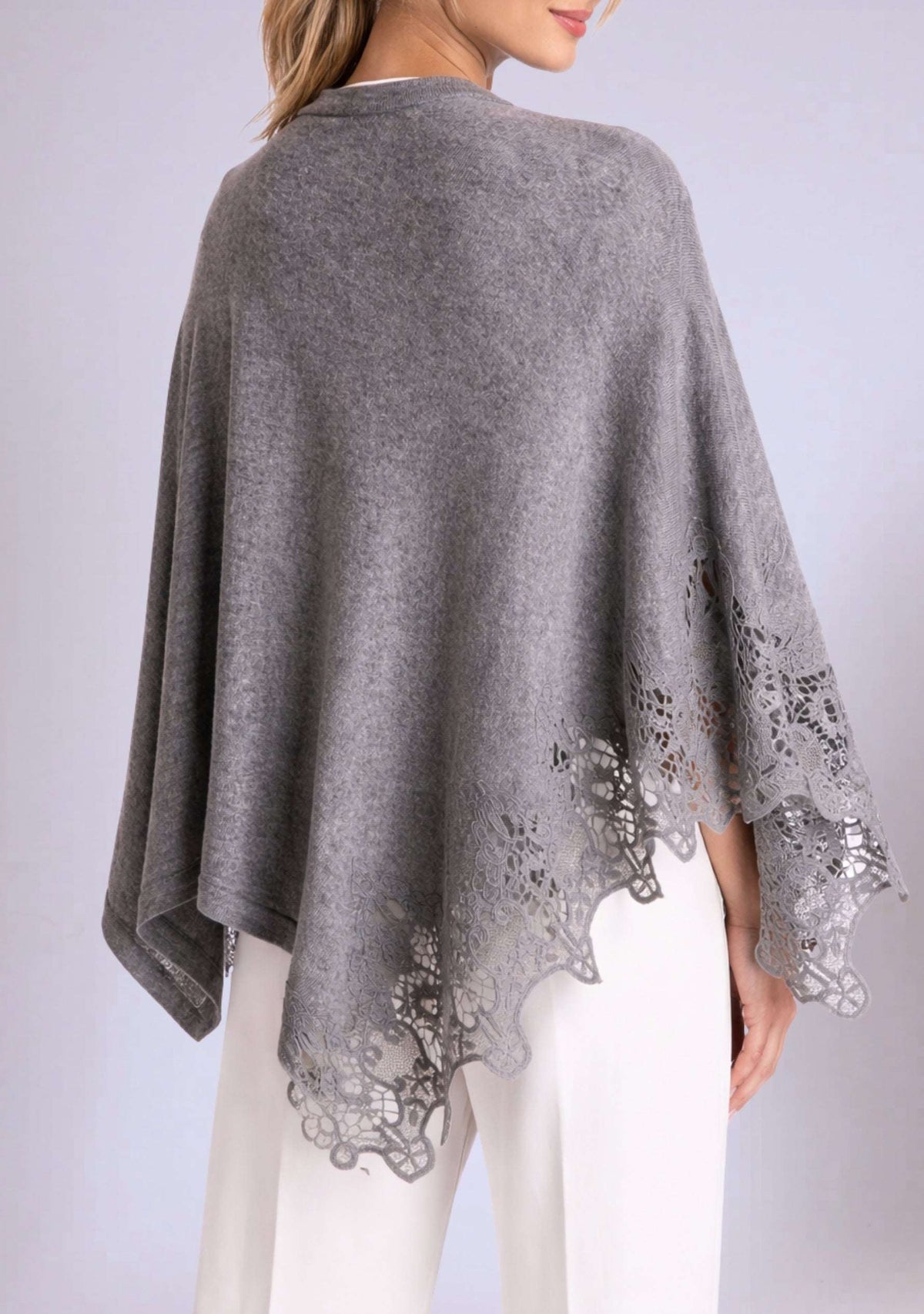 Gray poncho with lace details on a plain background