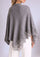 Gray poncho with lace details on a plain background