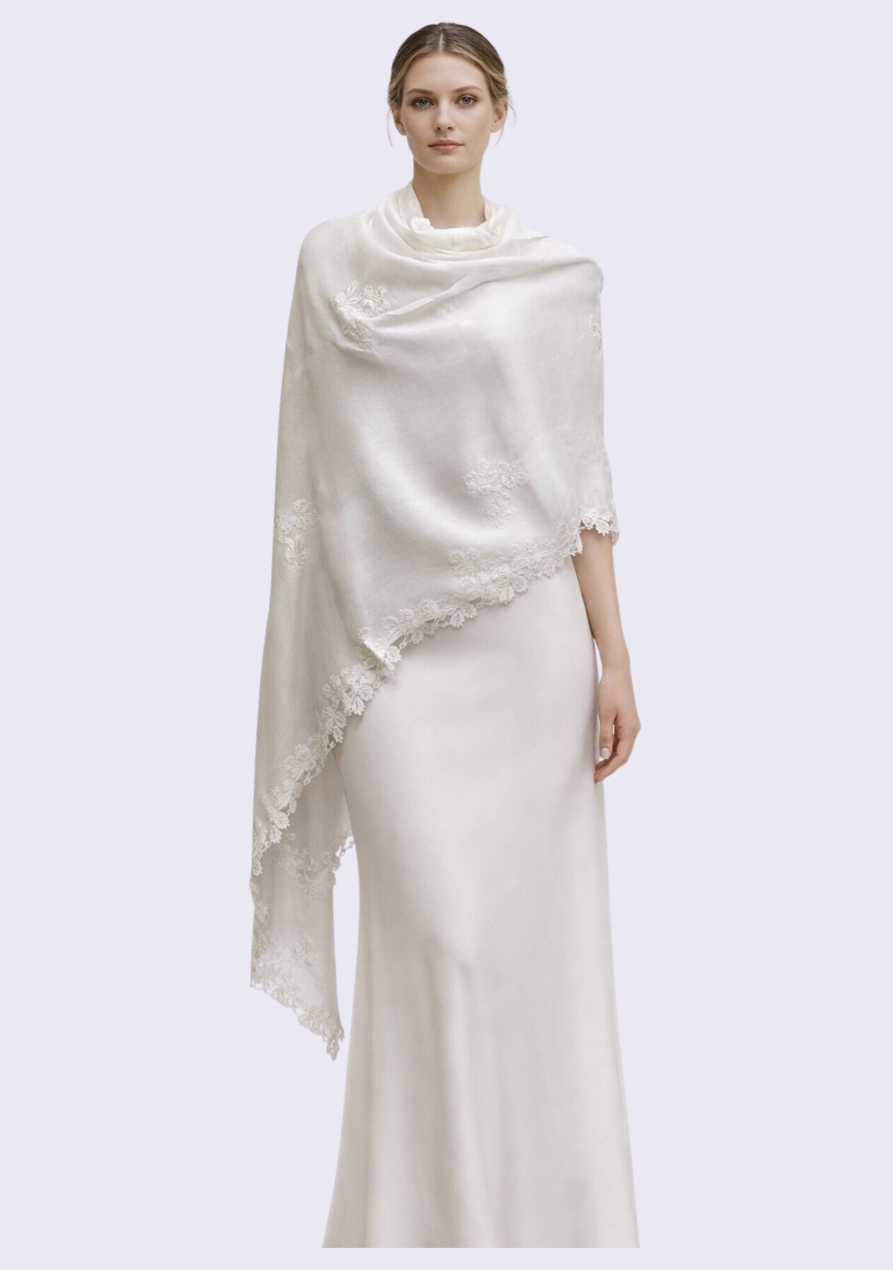 Woman wearing a white dress and shawl on a light gray background