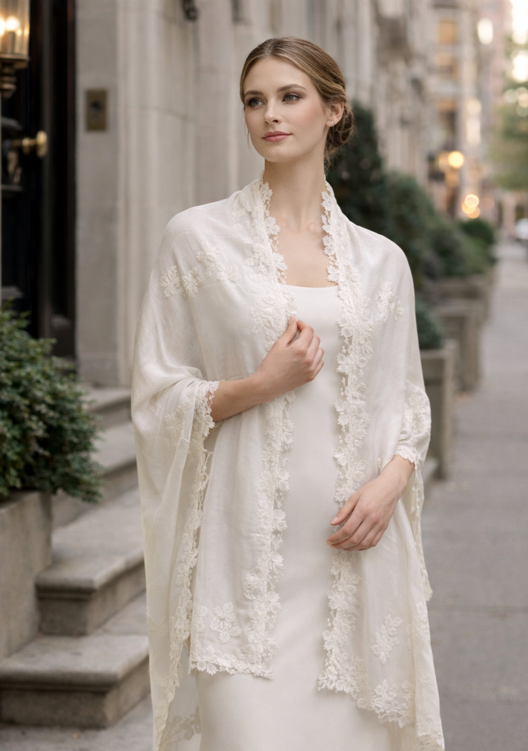 Woman wearing a white lace shawl in an urban setting