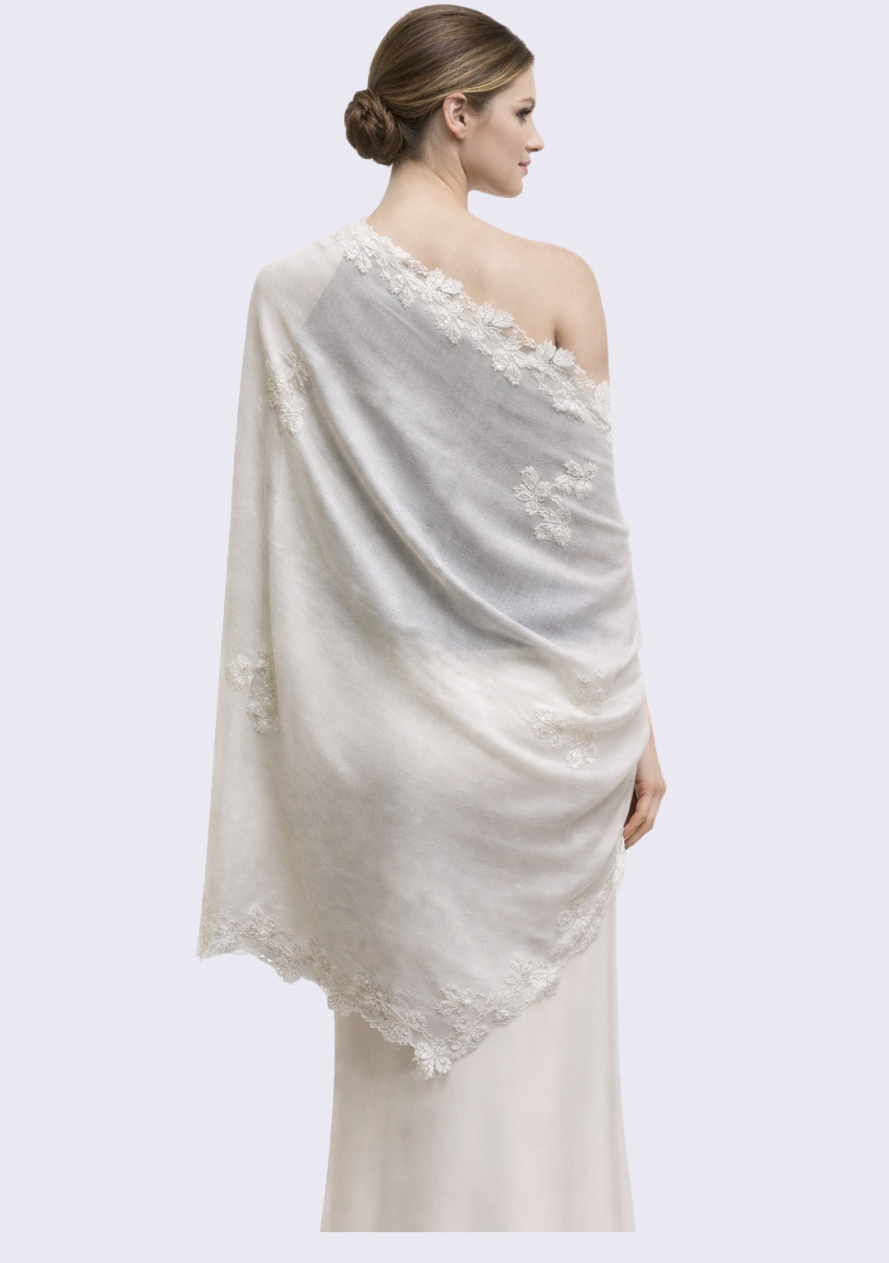 Woman wearing a light gray shawl with lace details on a white background Maneesha Ruia ivory scarf