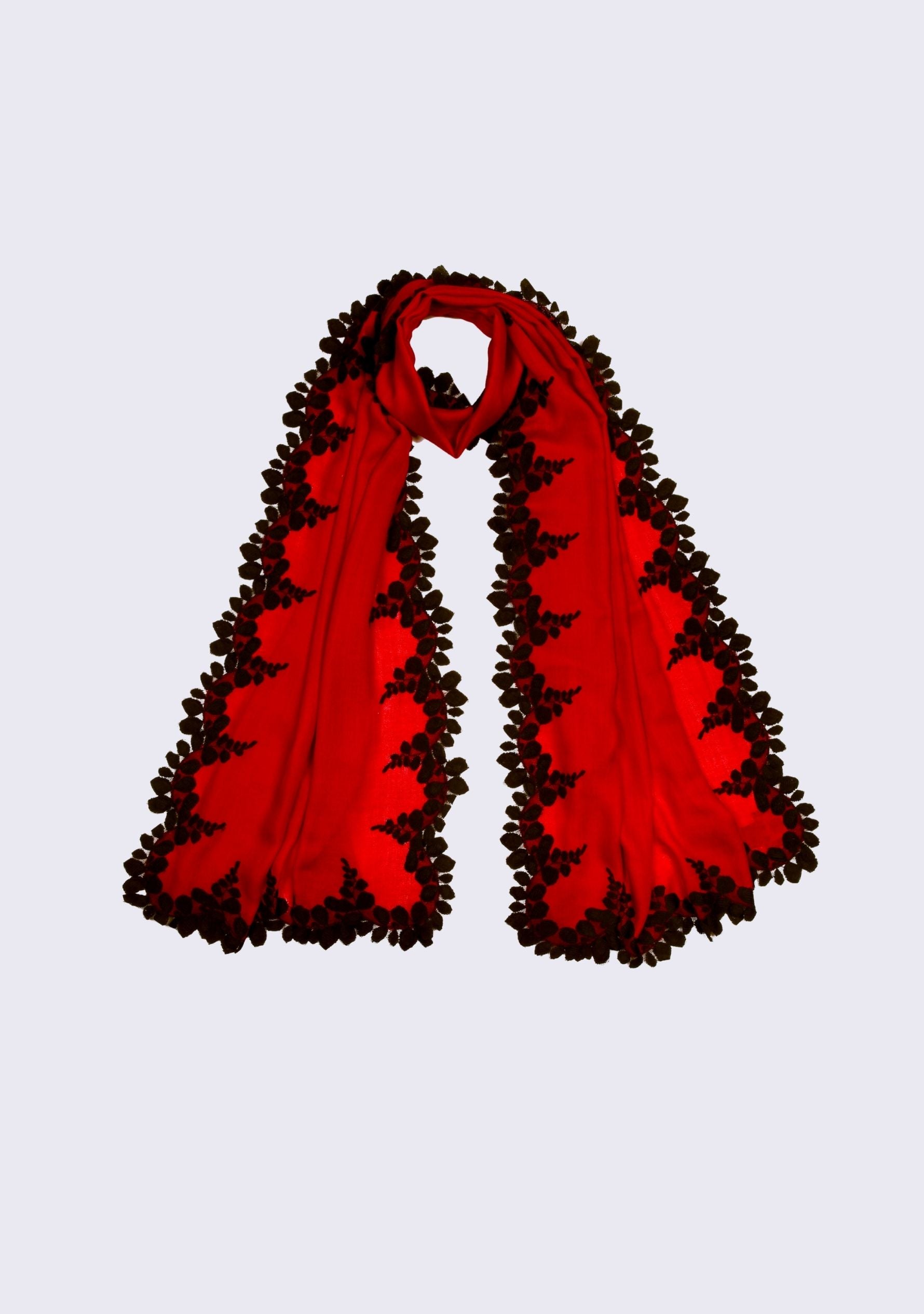 Red scarf with black trim on a light gray background