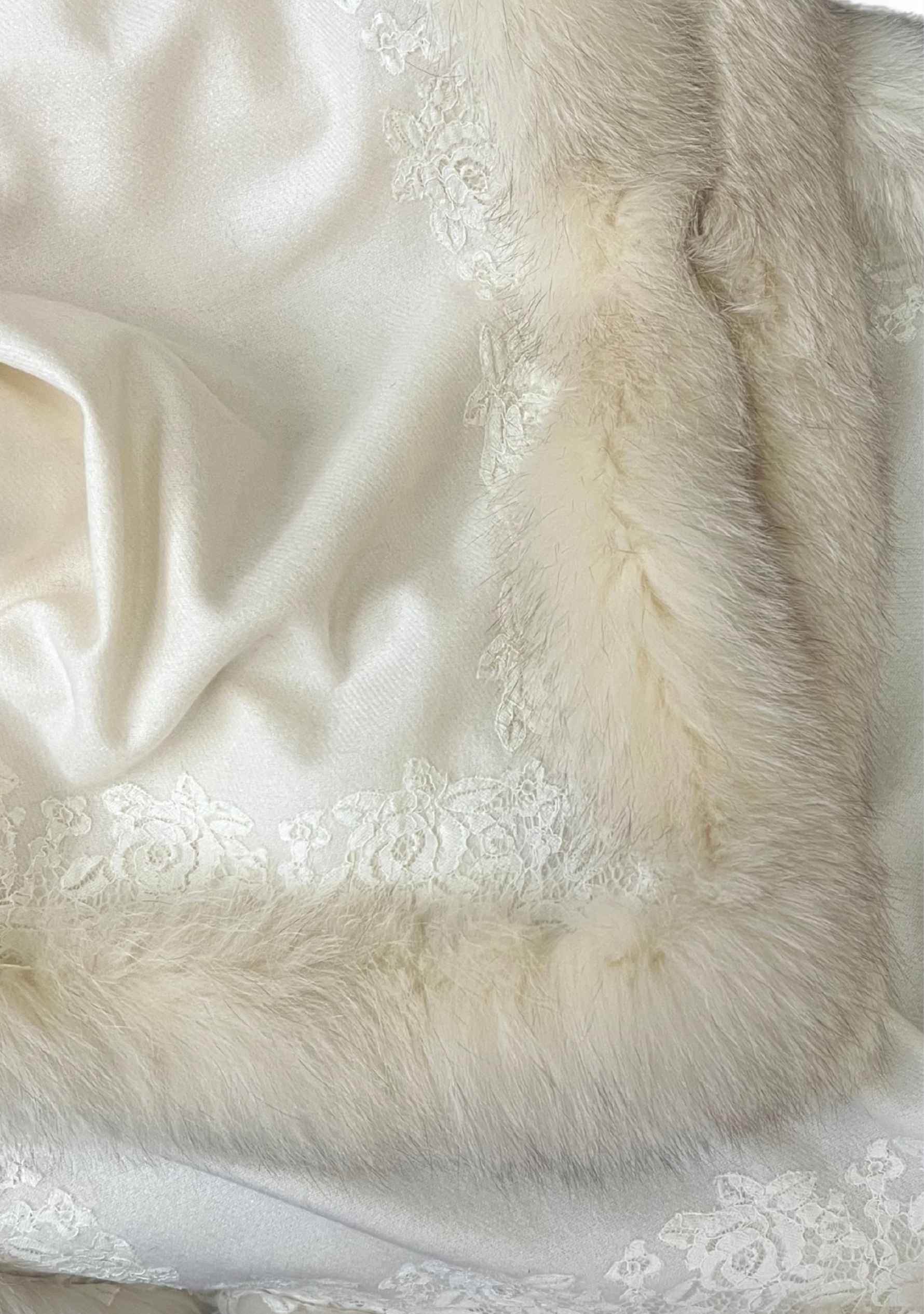 Close-up of a white fur cape with lace detailing