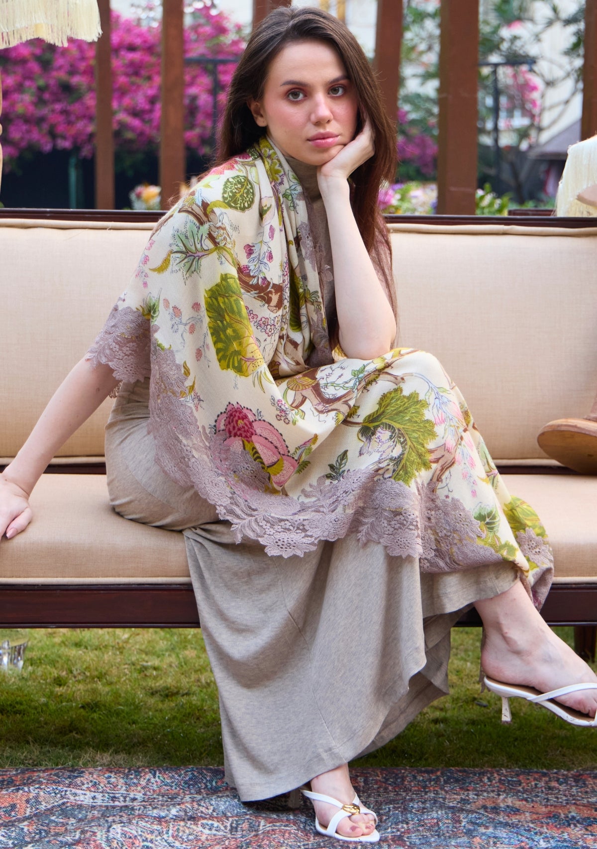 Wrap yourself in the ethereal beauty of this intricate, multi-colored Jacobean print scarf. Delicate motifs unfold gracefully across the ivory base, finished with a natural floral lace trim that adds depth and refinement to this wearable art. Crafted from a luxurious blend of wool and silk, this scarf offers a graceful drape with a soft, lightweight feel.