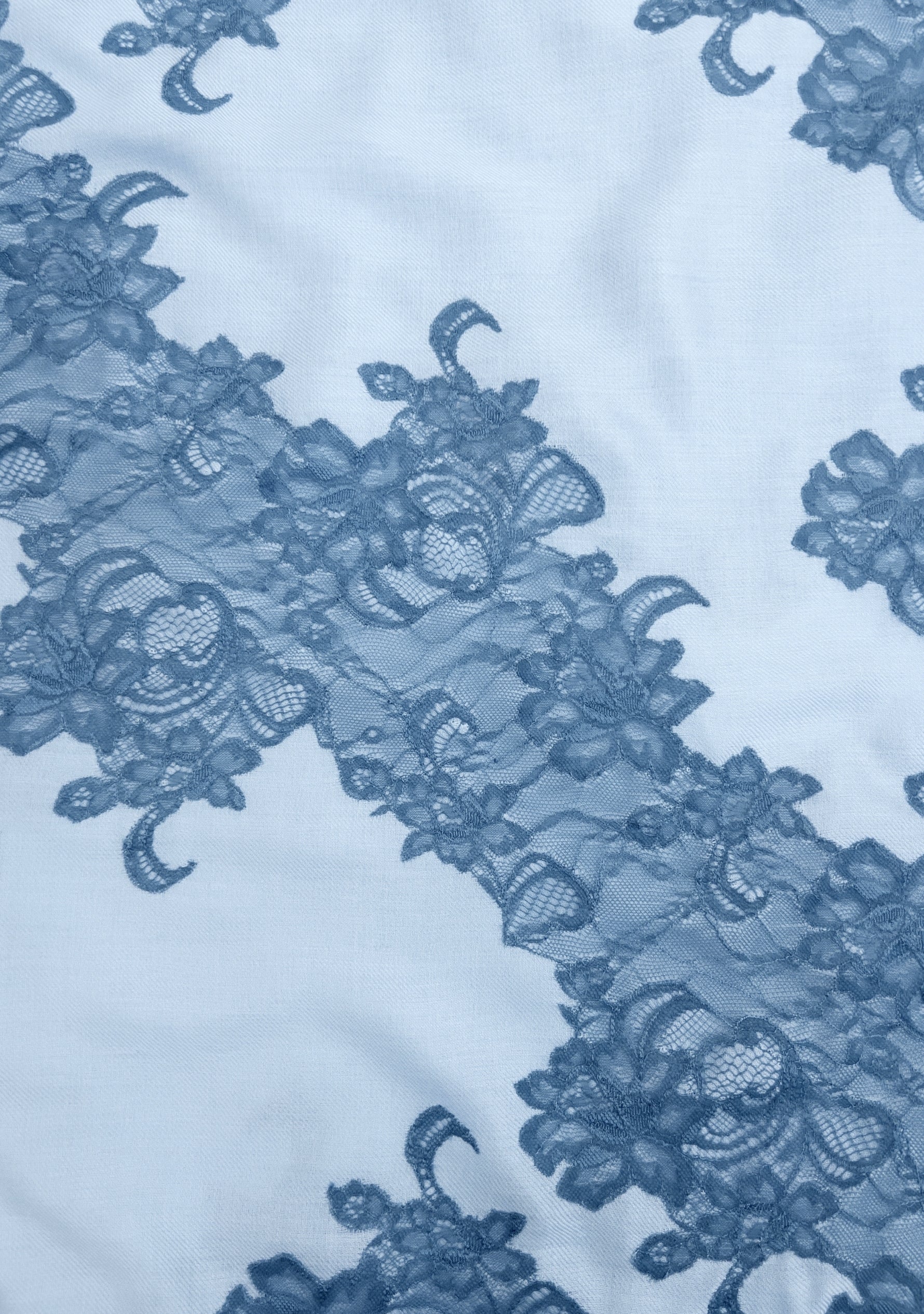 Blue lace fabric on a light blue background