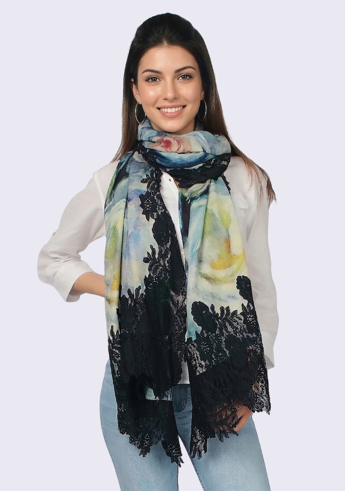 Woman wearing a colorful scarf with a black lace pattern on a light gray background