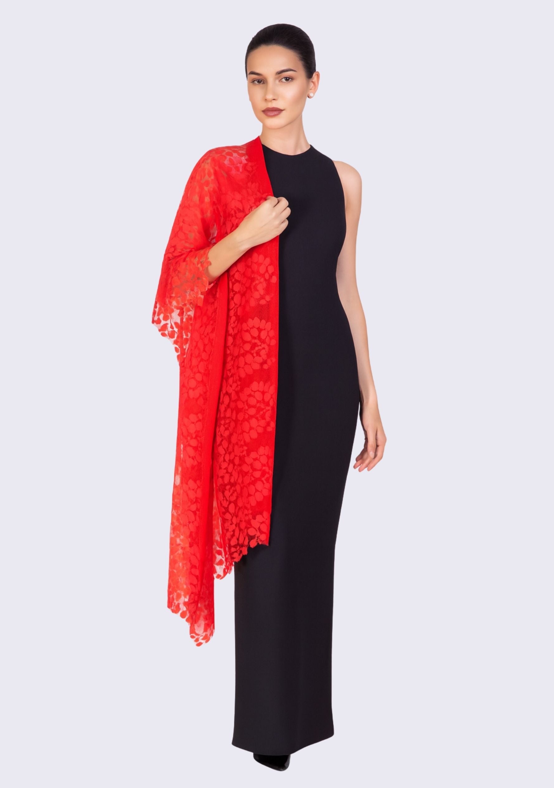 Woman wearing a black dress with a red lace shawl on a white background