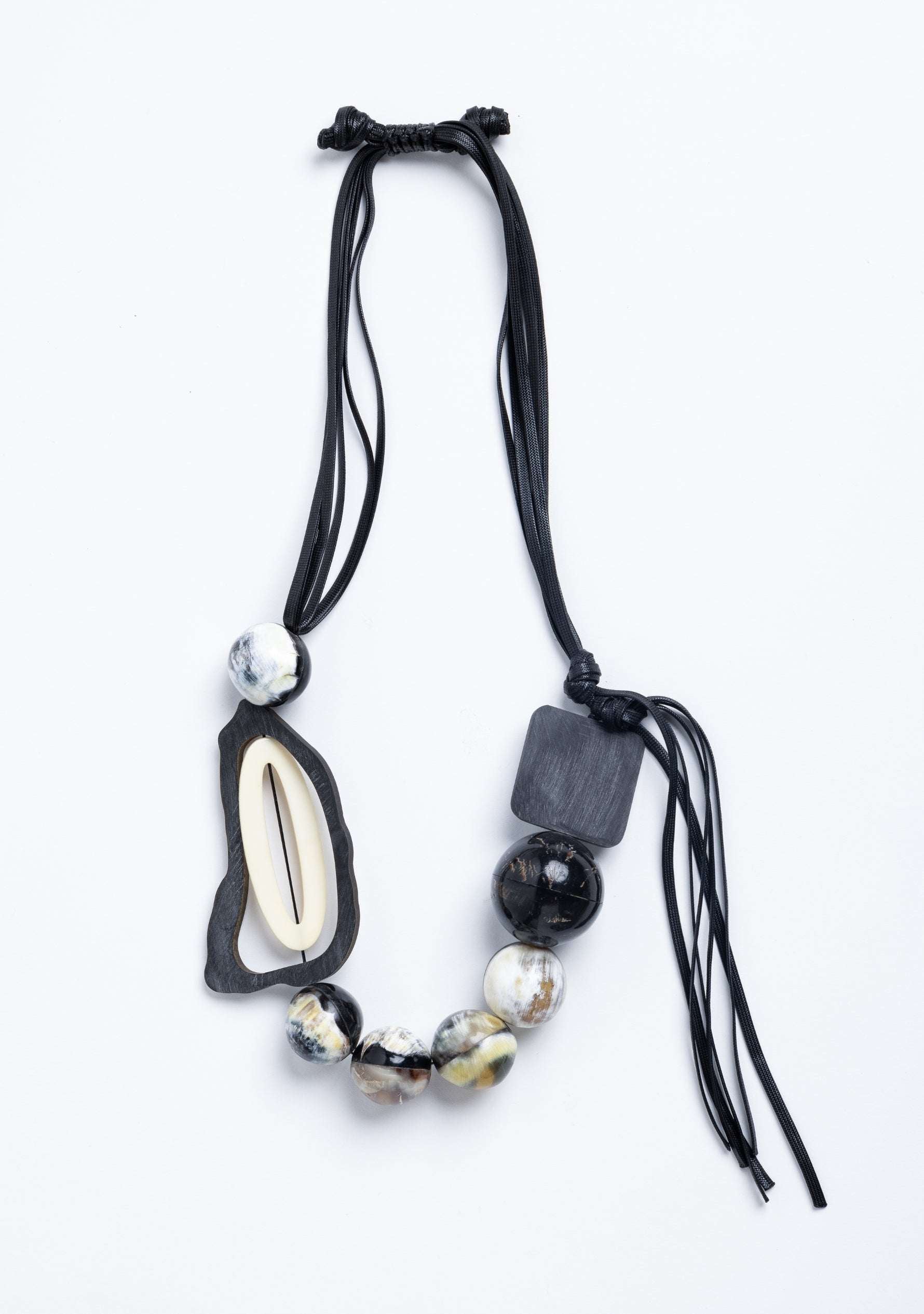 Black Cord Necklace with Black-Natural Buffalo Horn Balls and a White Resin "0" jewelry