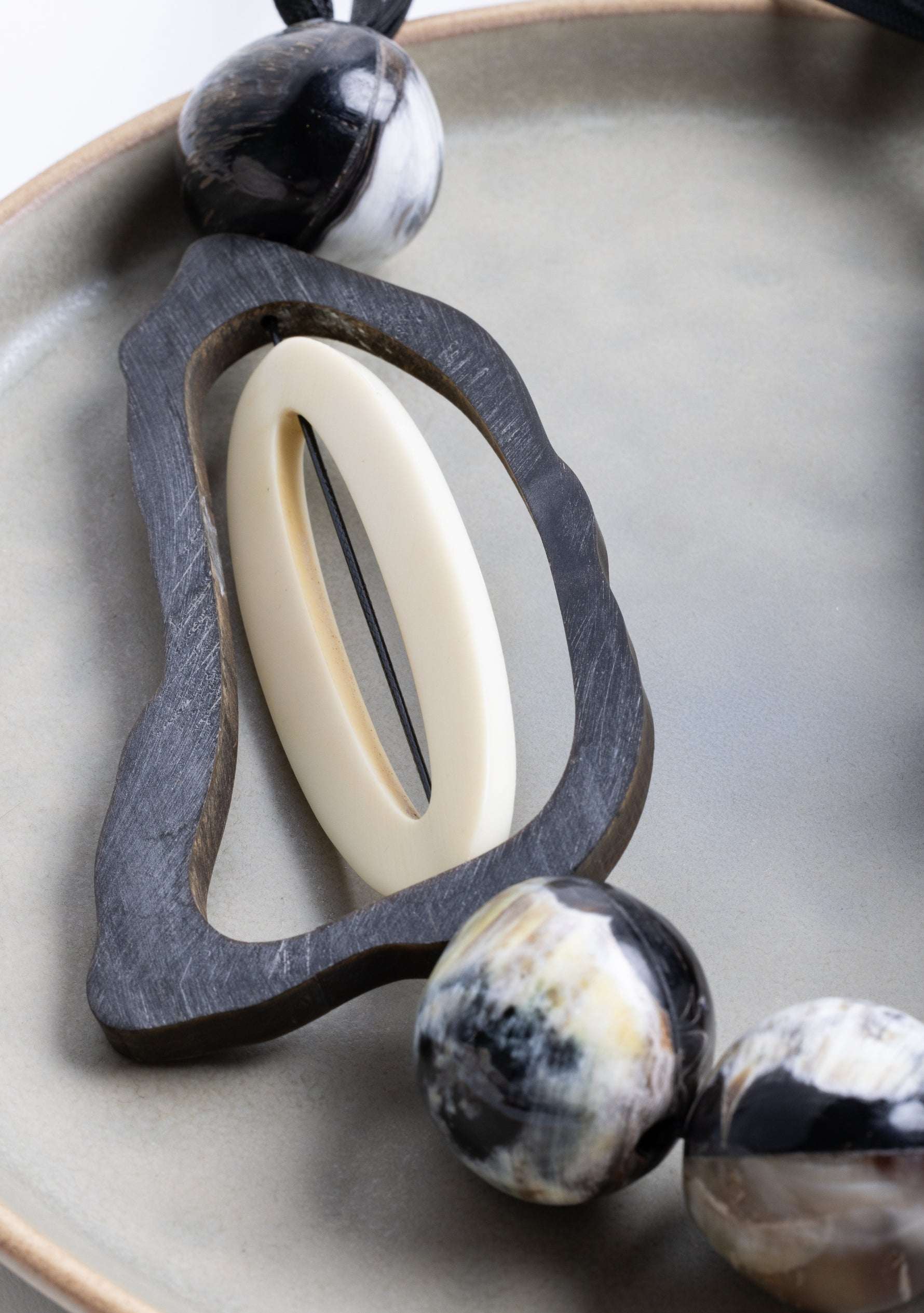 Black Cord Necklace with Black-Natural Buffalo Horn Balls and a White Resin "0" jewelry