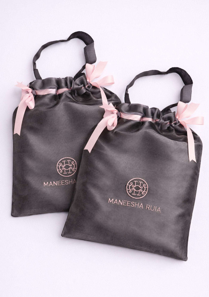 Complimentary Maneesha Ruia luxury satin gift bag included free with every scarf and wrap, perfect for gifting, storage, and travel.