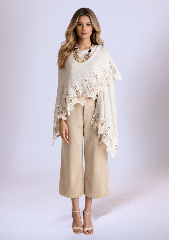 Woman wearing a Beige lace poncho over a beige outfit on a white background