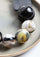 Black Cord Necklace with Black-Natural Buffalo Horn Balls and a White Resin "0" jewelry