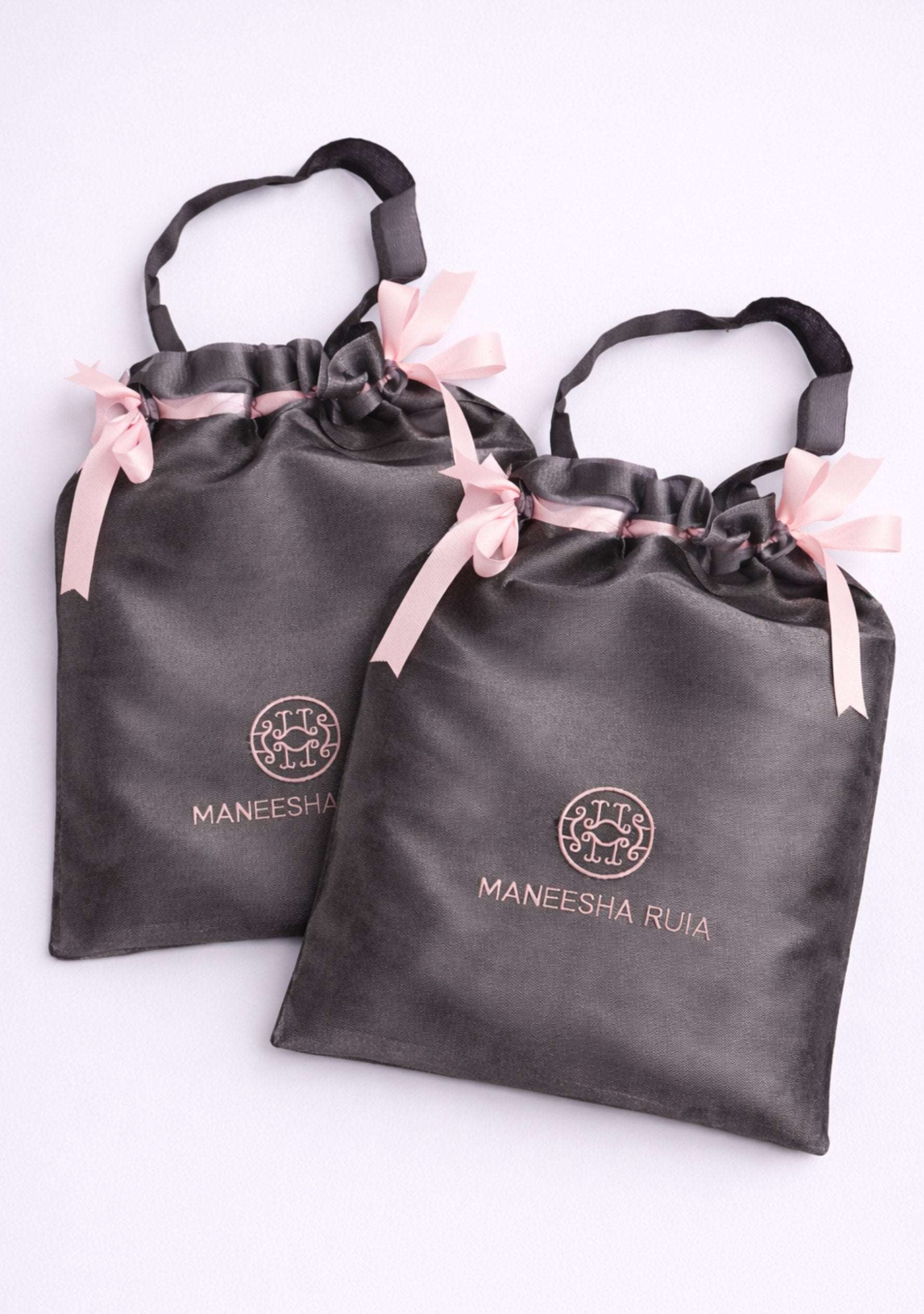 Complimentary Maneesha Ruia luxury satin gift bag included free with every scarf and wrap, perfect for gifting, storage, and travel.