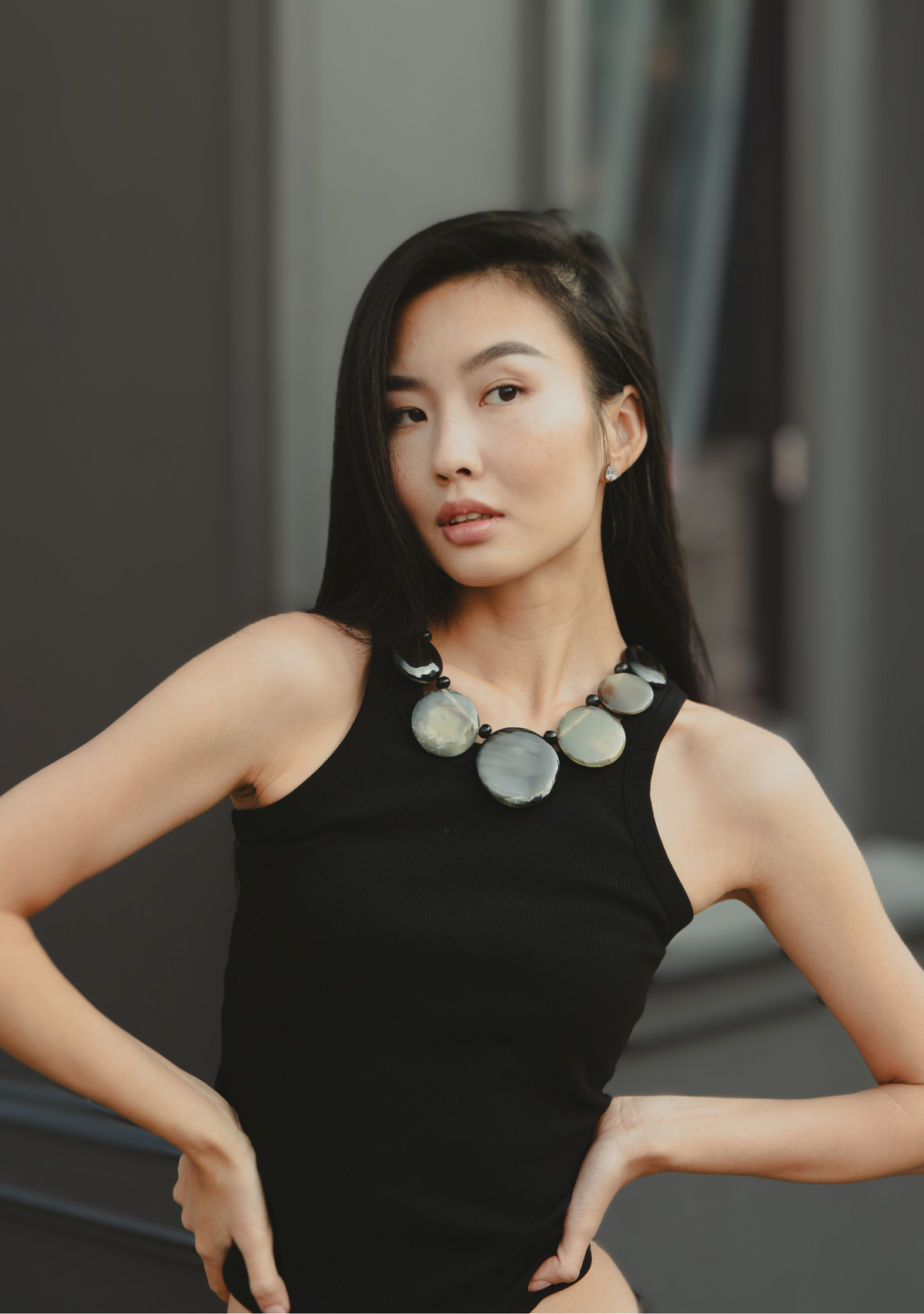 This one-of-a-kind pendant necklace features a black cord adorned with two small, uniquely-shaped white baroque pearls, a stunning natural-gold resin drop, and finally, completing the ensemble, a large, irregular-shaped ethically-sourced buffalo horn piece in an interplay between white and black. Whilst the pearls bring with it an organic beauty, the resin drop provides a warm, radiant glow with the buffalo horn adding an element of depth and visual interest. The combination of these elements creates a striking balance of textures and colors, making this a versatile accessory suitable for both casual and formal occasions. Lightweight and thoughtfully crafted, this necklace celebrates sustainable materials and showcases the artistry of handmade jewelry, perfect for those who appreciate unique and ethical fashion.