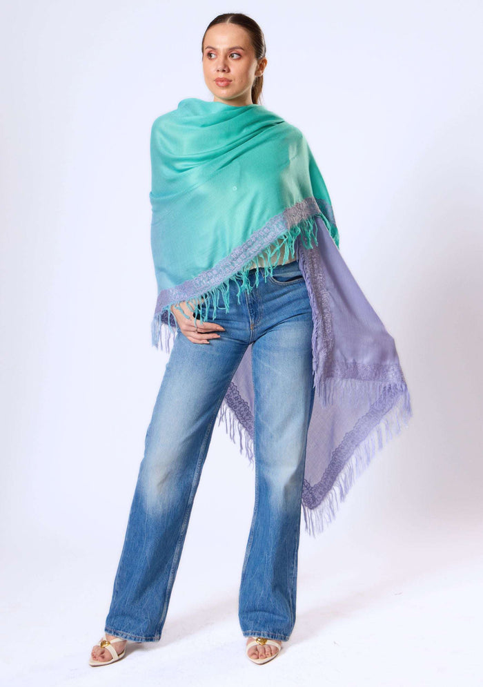 Maneesha Ruia Aqua Ombré Modal & Cashmere Scarf with Lavender Lace Fringes, styled as an elegant wrap on a model, showcasing the soft aqua-to-lavender gradient and delicate lace trim.