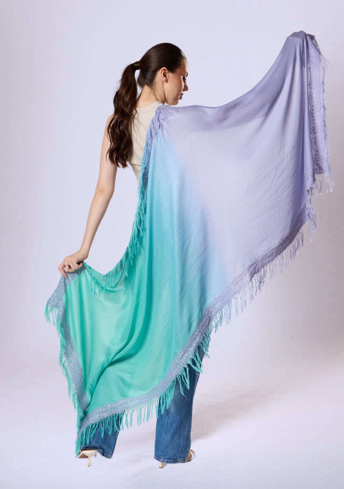 Back view of the Maneesha Ruia Aqua Ombré Modal & Cashmere Scarf with Lavender Lace Fringes, showcasing the flowing aqua-to-lavender gradient, delicate lace trim, and elegant drape.