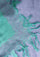 Close-up of the Maneesha Ruia Aqua Ombré Modal & Cashmere Scarf featuring lavender floral lace trim, aqua-to-lavender ombré fabric, and hand-knotted fringes.