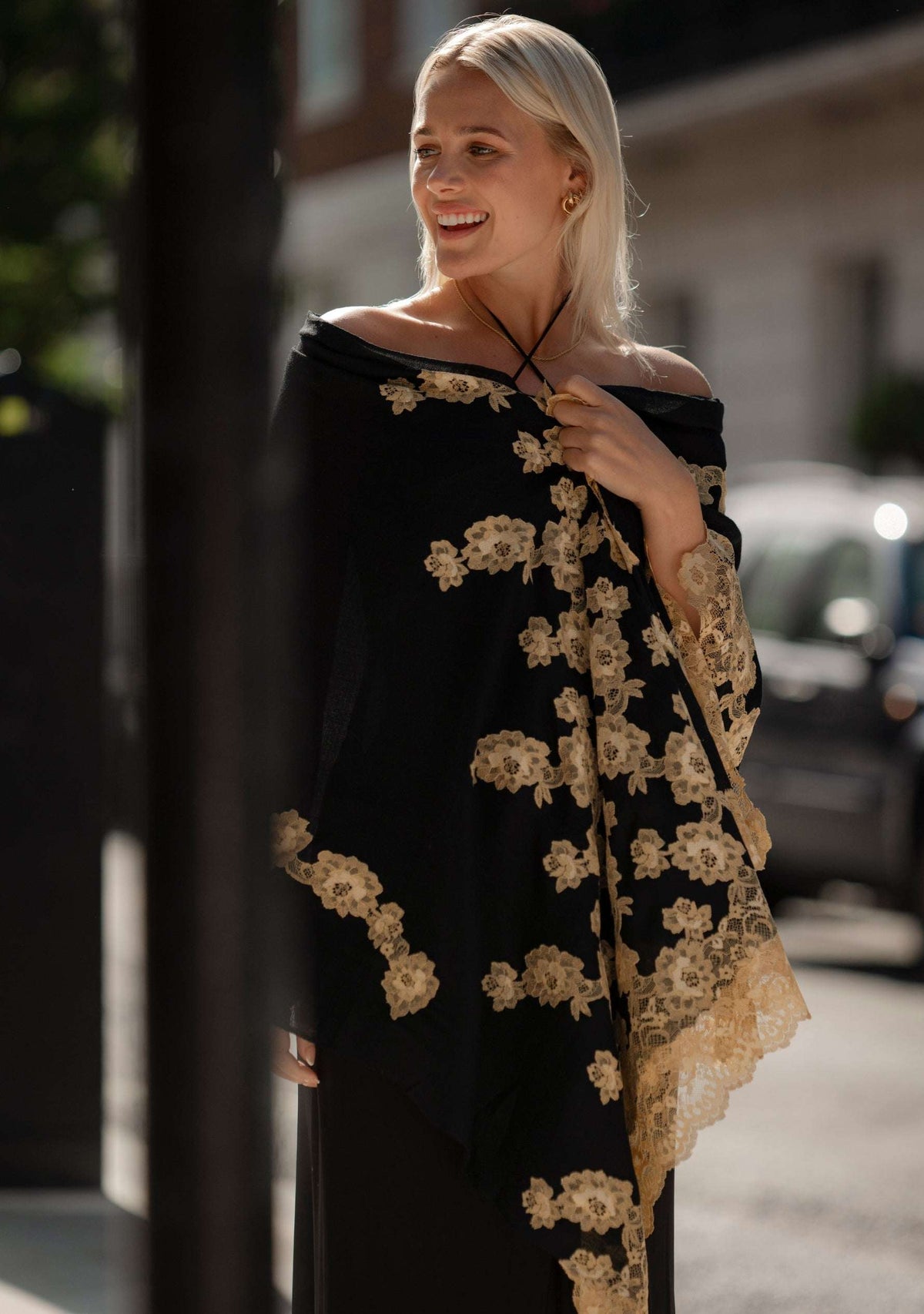 Luxury black cashmere scarf with handcrafted gold Chantilly lace in a floral vine pattern, perfect for formal occasions and timeless luxury styling.