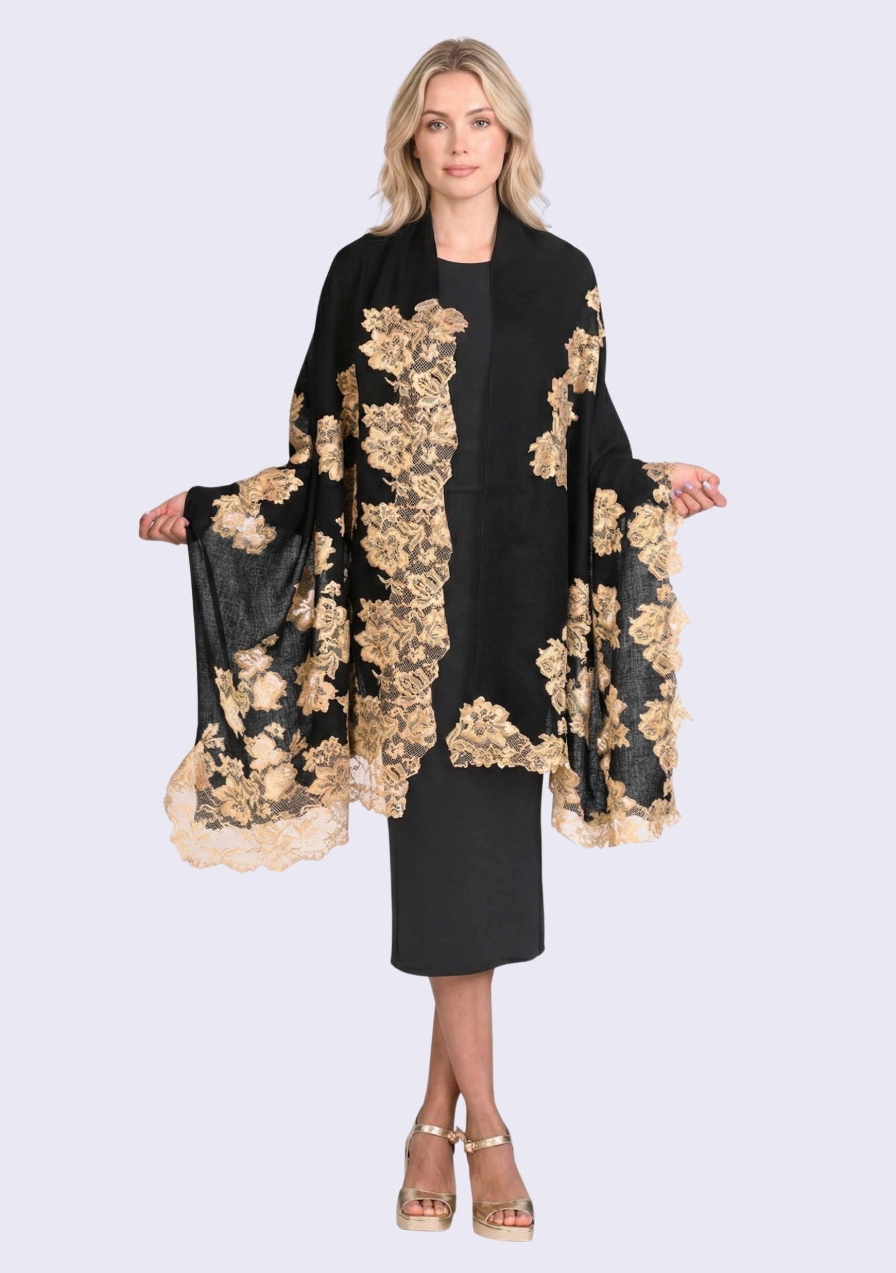 Luxury black cashmere scarf with handcrafted gold Chantilly lace in a floral vine pattern, elegantly draped on a smiling female model wearing a black off-shoulder dress. Soft, lightweight designer scarf with intricate lace detailing, perfect for formal occasions and timeless luxury styling.