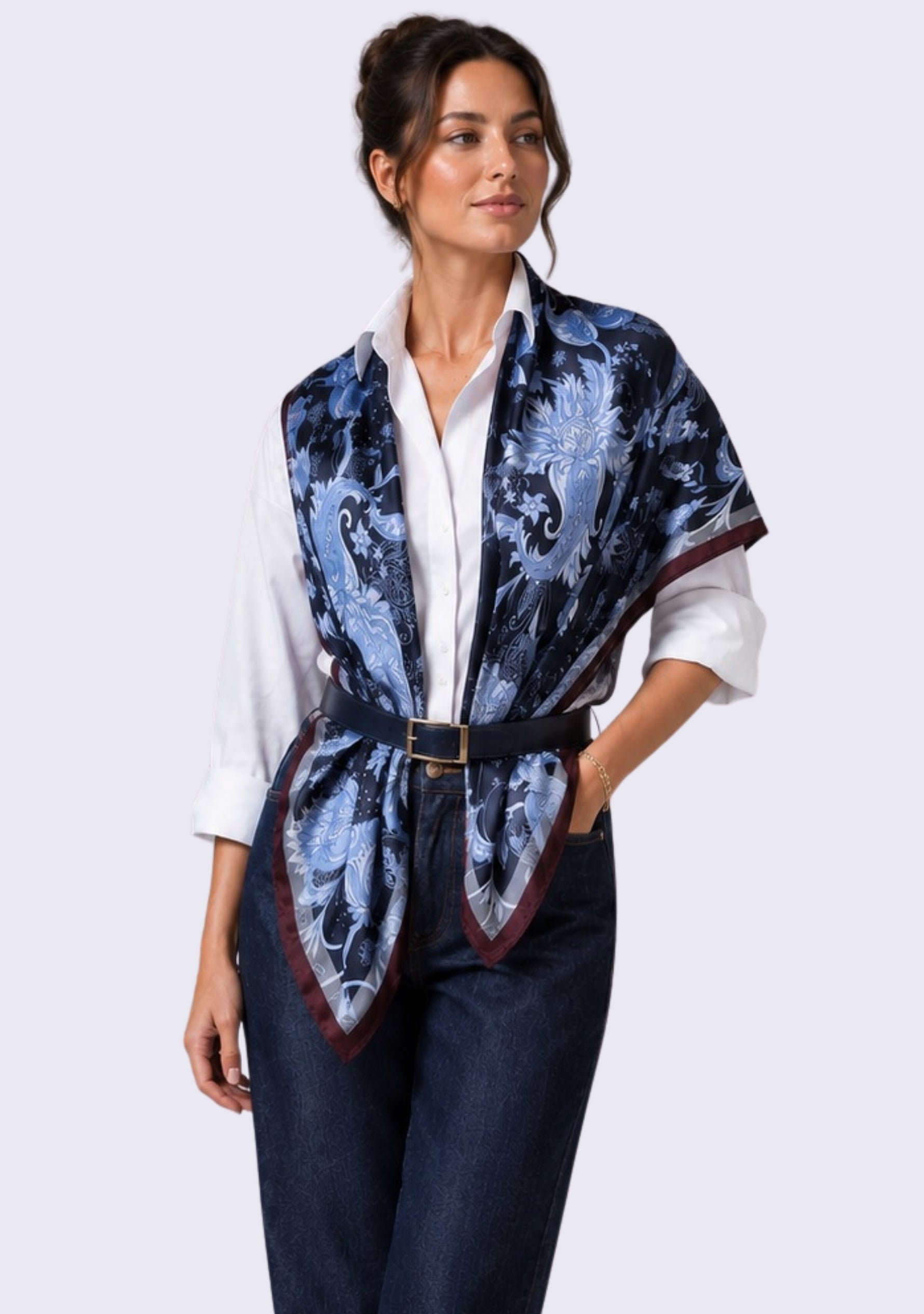 Maneesha Ruia Blue & Brown Jacobean Print Silk Twill Square Scarf with Silver & Gunmetal Swarovski Crystals styled as an elegant silk vest over an ivory shirt with tailored denim.