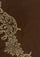 A close-up of a dark brown scarf with an ornate metallic gold floral and scroll pattern along the left side.