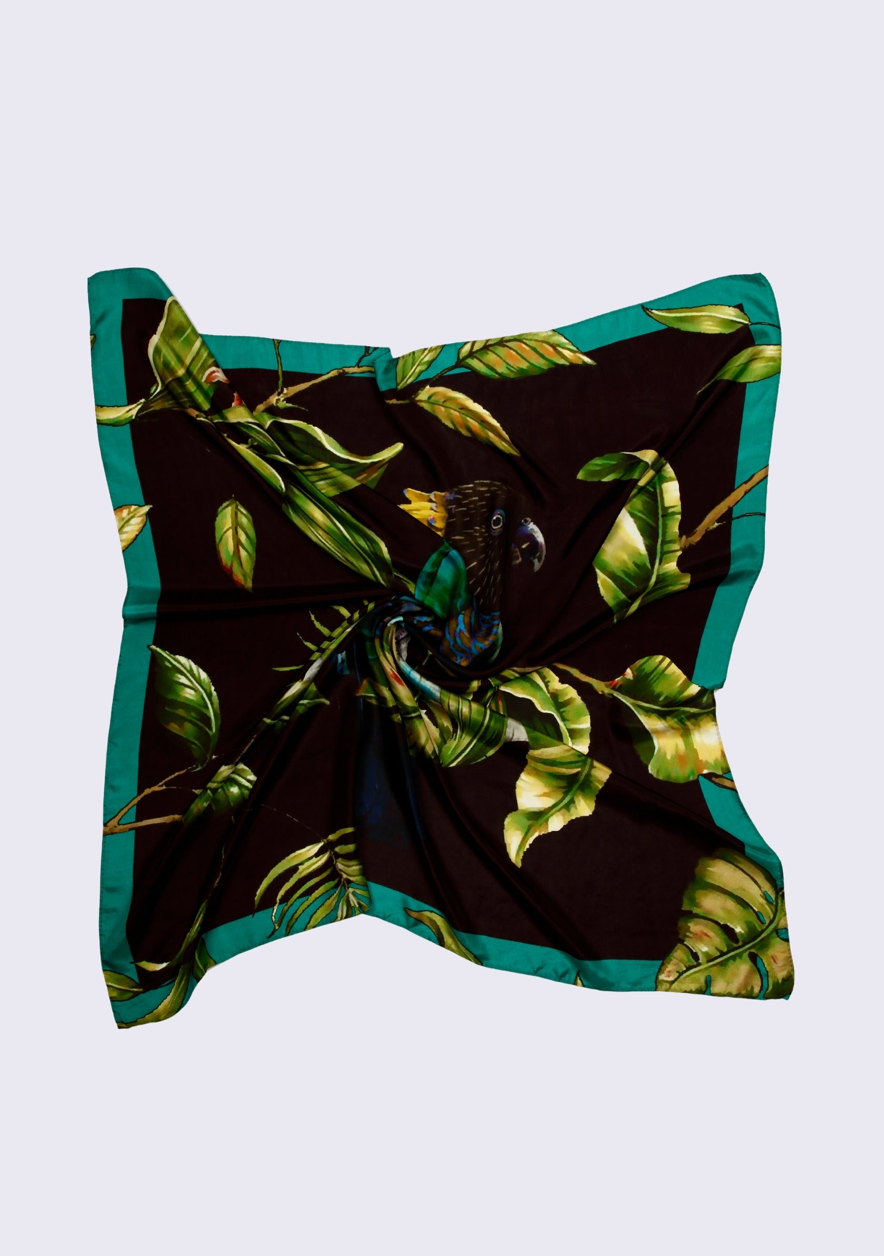 Cockatoo Print Silk Square Scarf by Maneesha Ruia featuring a vibrant cockatoo motif with lush green tropical foliage and teal border on luxurious 100% silk.