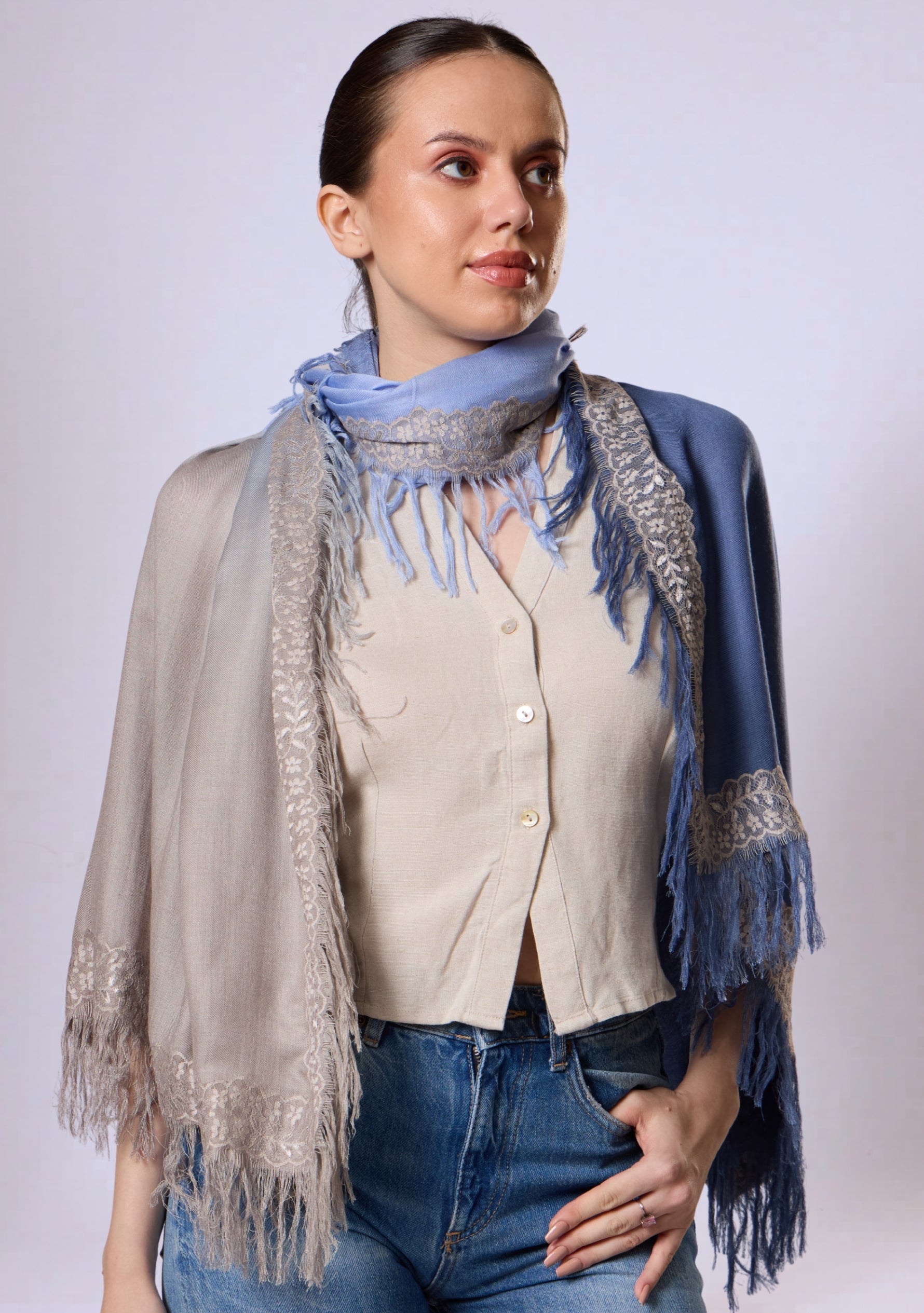 Maneesha Ruia Denim Ombré Modal & Cashmere Scarf with Mousse Lace Fringes, styled on a model in a layered wrap, showcasing the light blue to denim blue gradient and delicate lace trim.