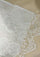 Close-up of a lace scarf with a beige background