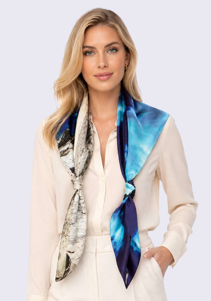 Woman wearing a colorful scarf with a white background