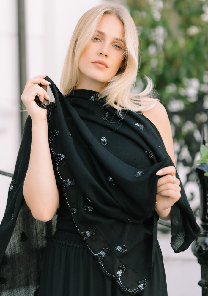 Black cashmere scarf featuring a brooch-inspired black beaded design, finished with a scalloped organza border and hand-beaded edges
