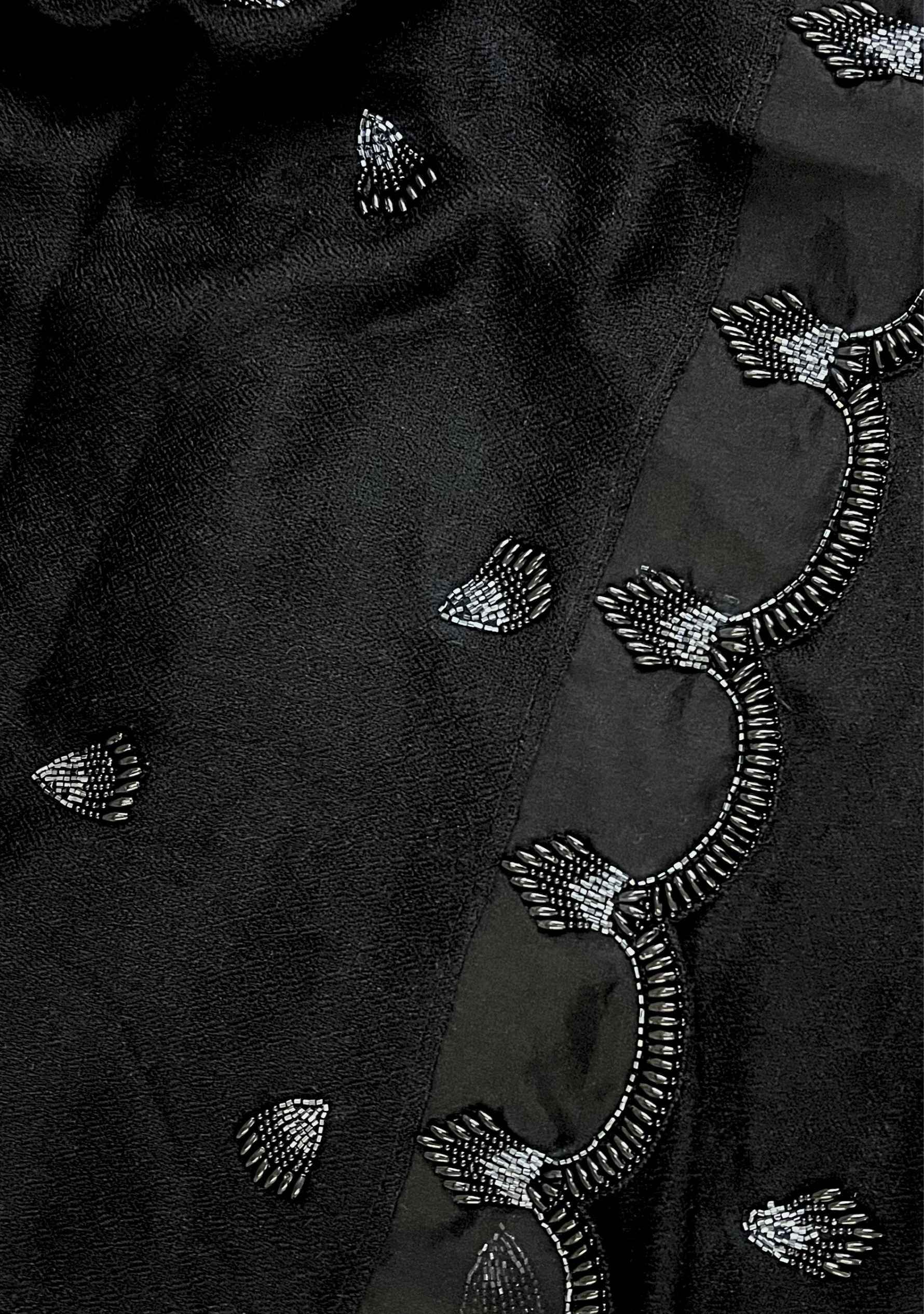 Black cashmere scarf featuring a brooch-inspired black beaded design, finished with a scalloped organza border and hand-beaded edges