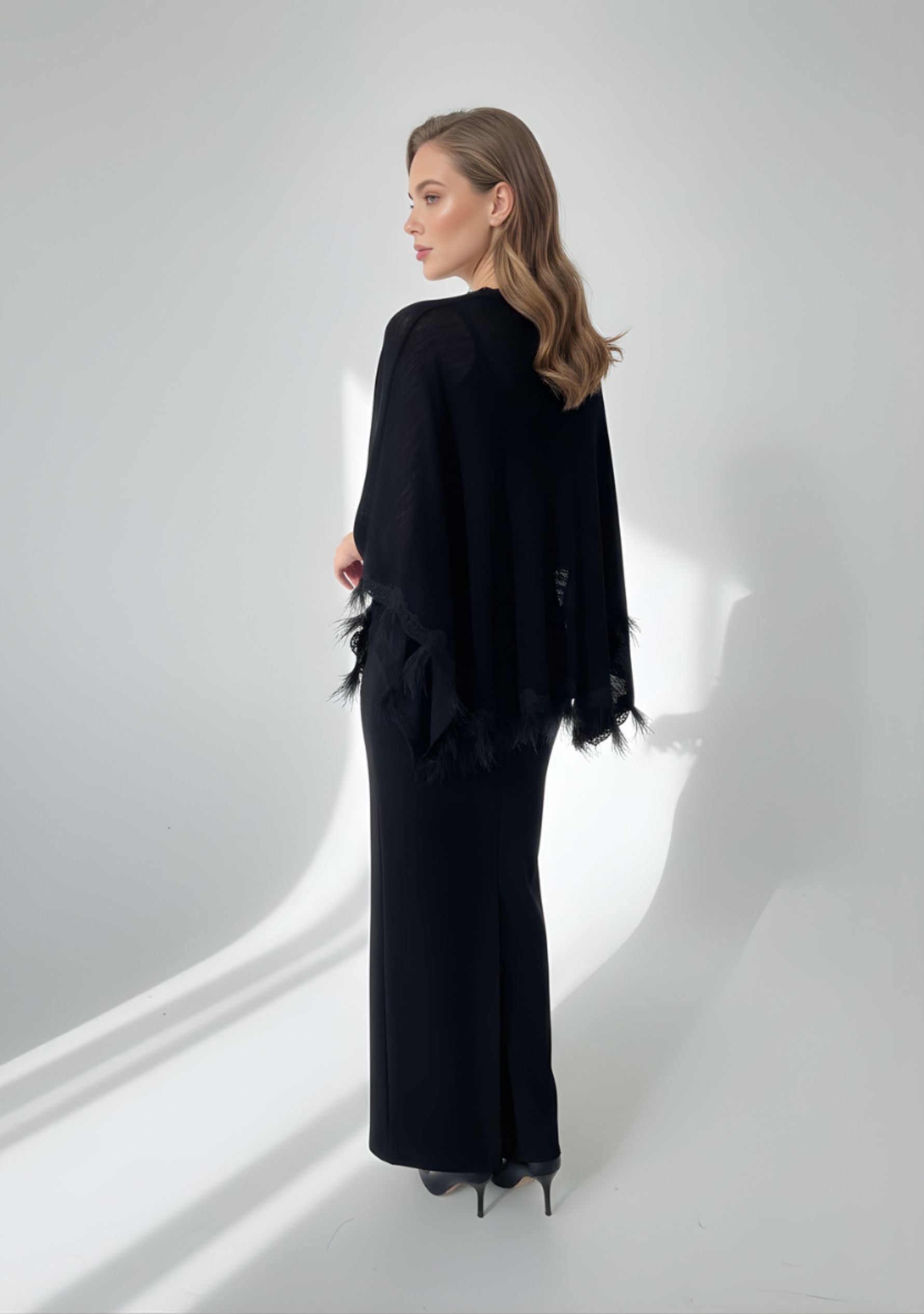 Black knitted merino wool cape with scalloped black lace and ostrich feathers
