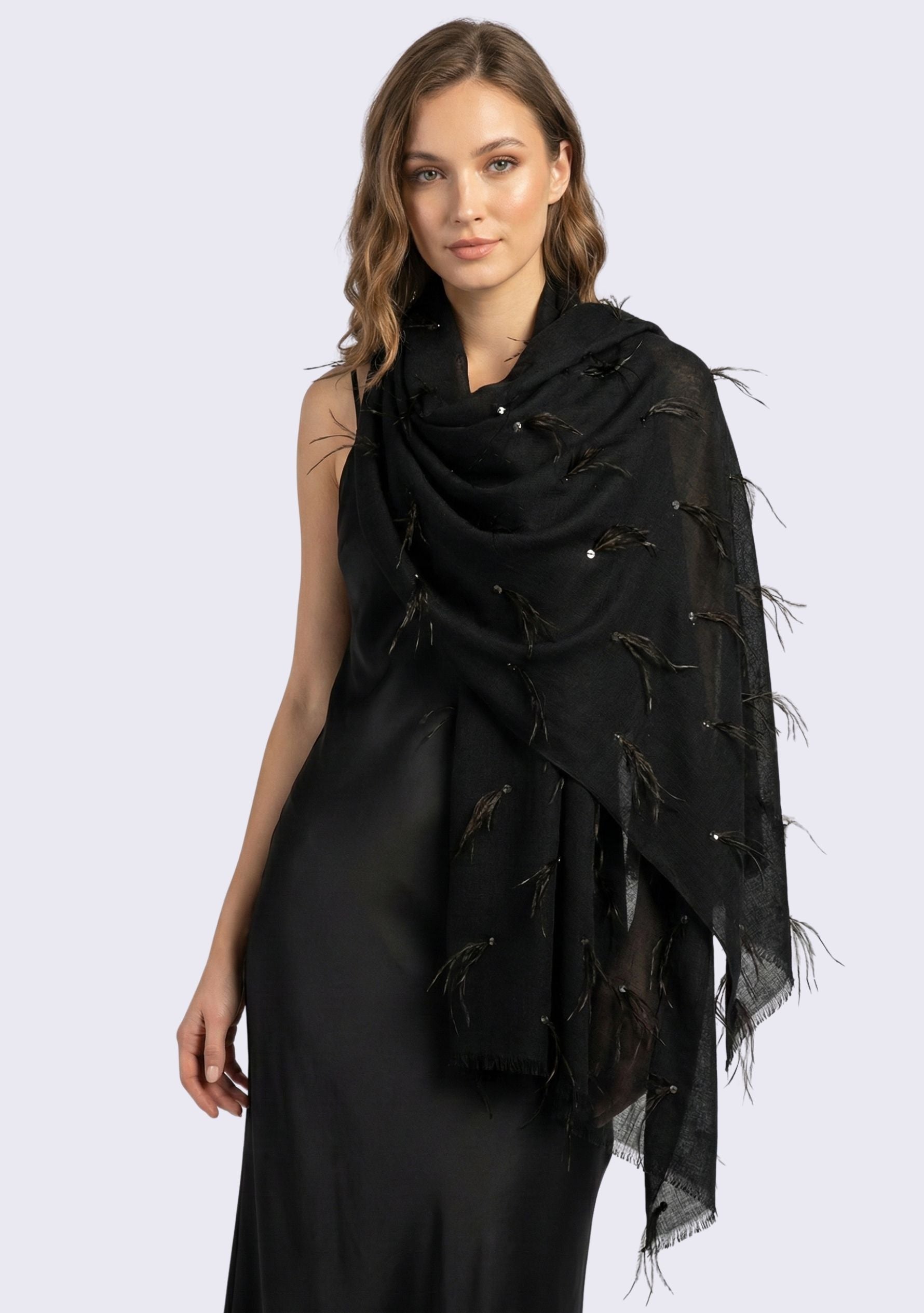 Woman wearing a black scarf with feather details on a white background