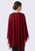 Red poncho with lace trim worn by a person on a white background
