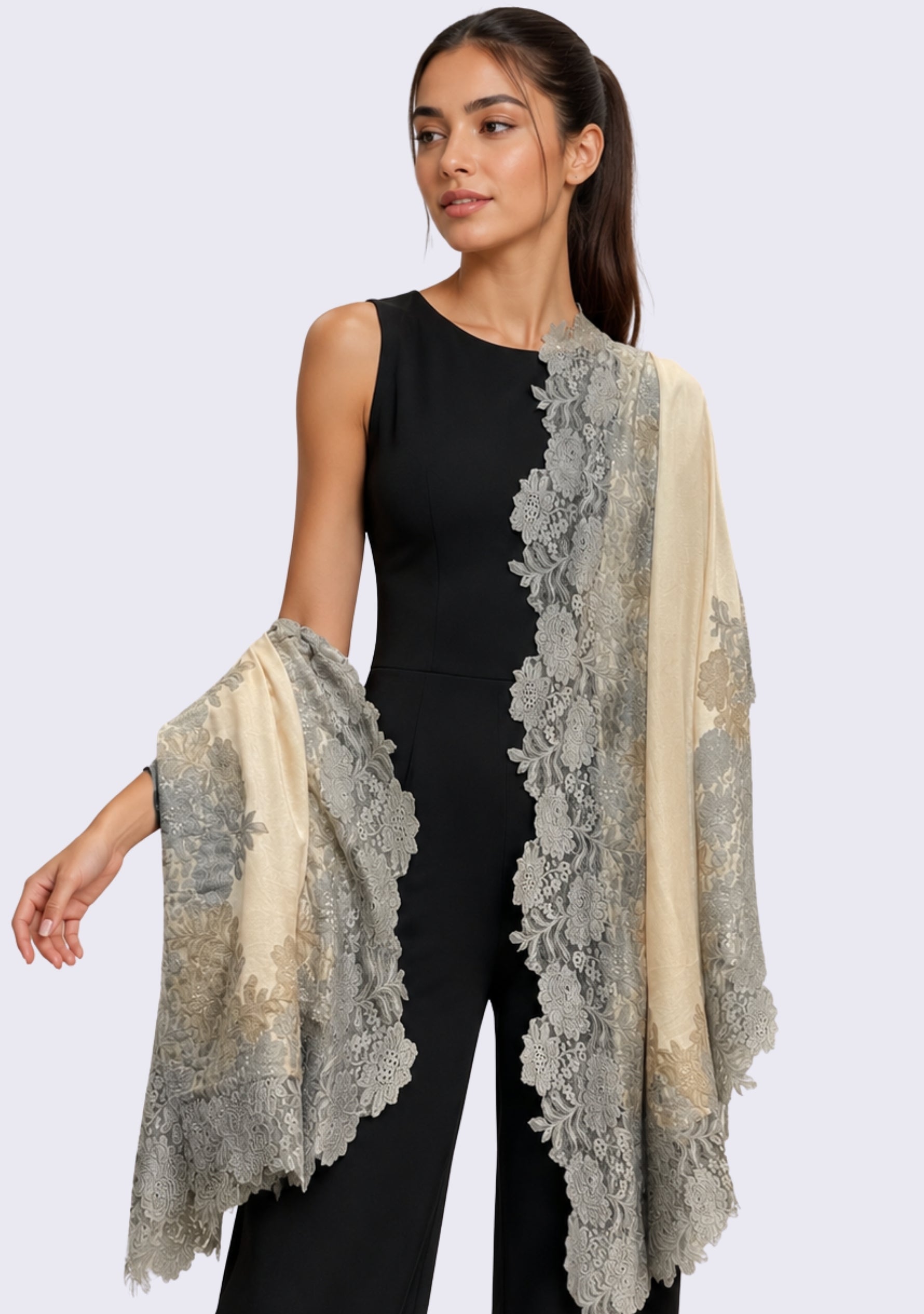 Female model wearing a luxury beige wool and silk scarf with handcrafted mousse and dark beige Chantilly floral lace, elegantly draped over a black sleeveless outfit to showcase its lightweight fabric and intricate floral lace detailing.