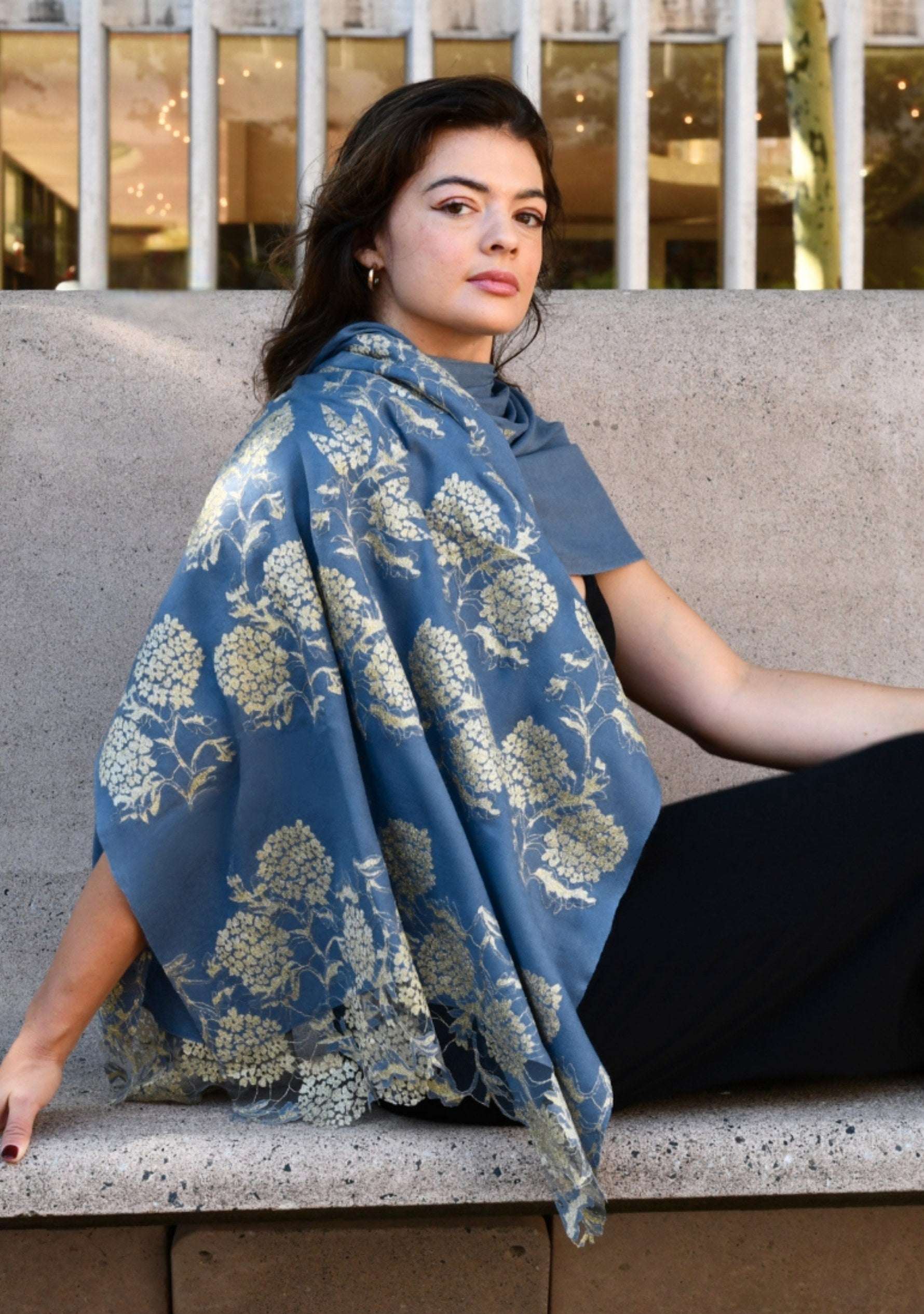 Woman wearing a Maneesha Ruia denim blue wool and silk scarf with gold lace, luxury designer scarf for women