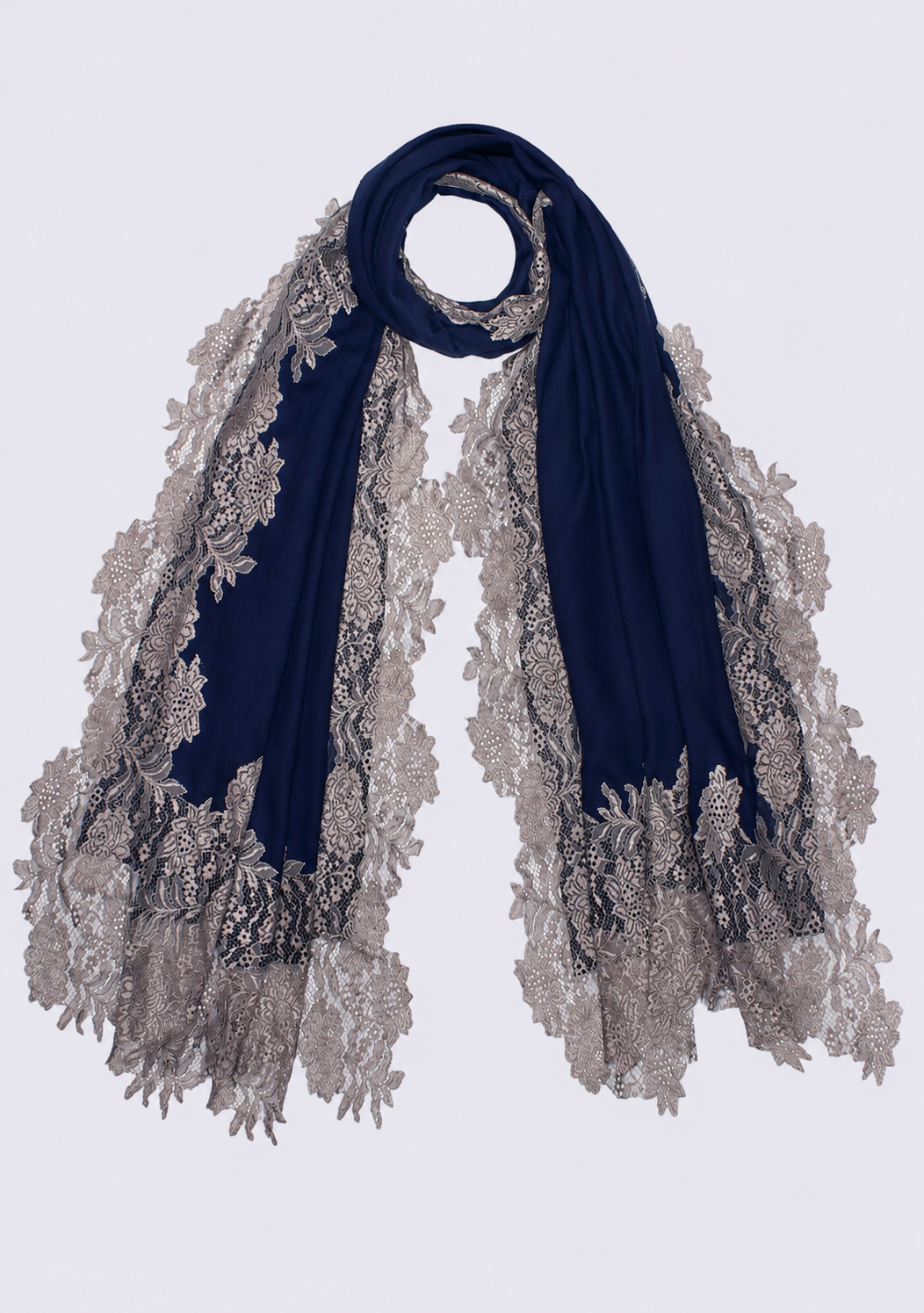 A dark denim blue scarf with intricate silver-gray floral lace trim, draped elegantly against a light gray background.