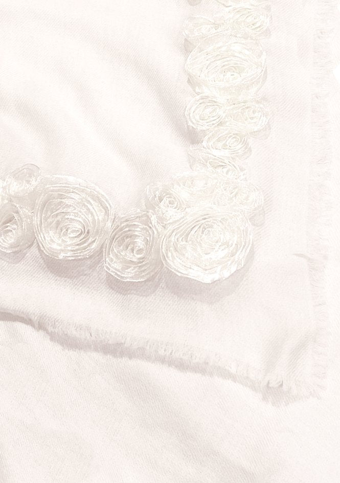 Close-up of a Maneesha Ruia ivory cashmere scarf with ivory ribbon roses