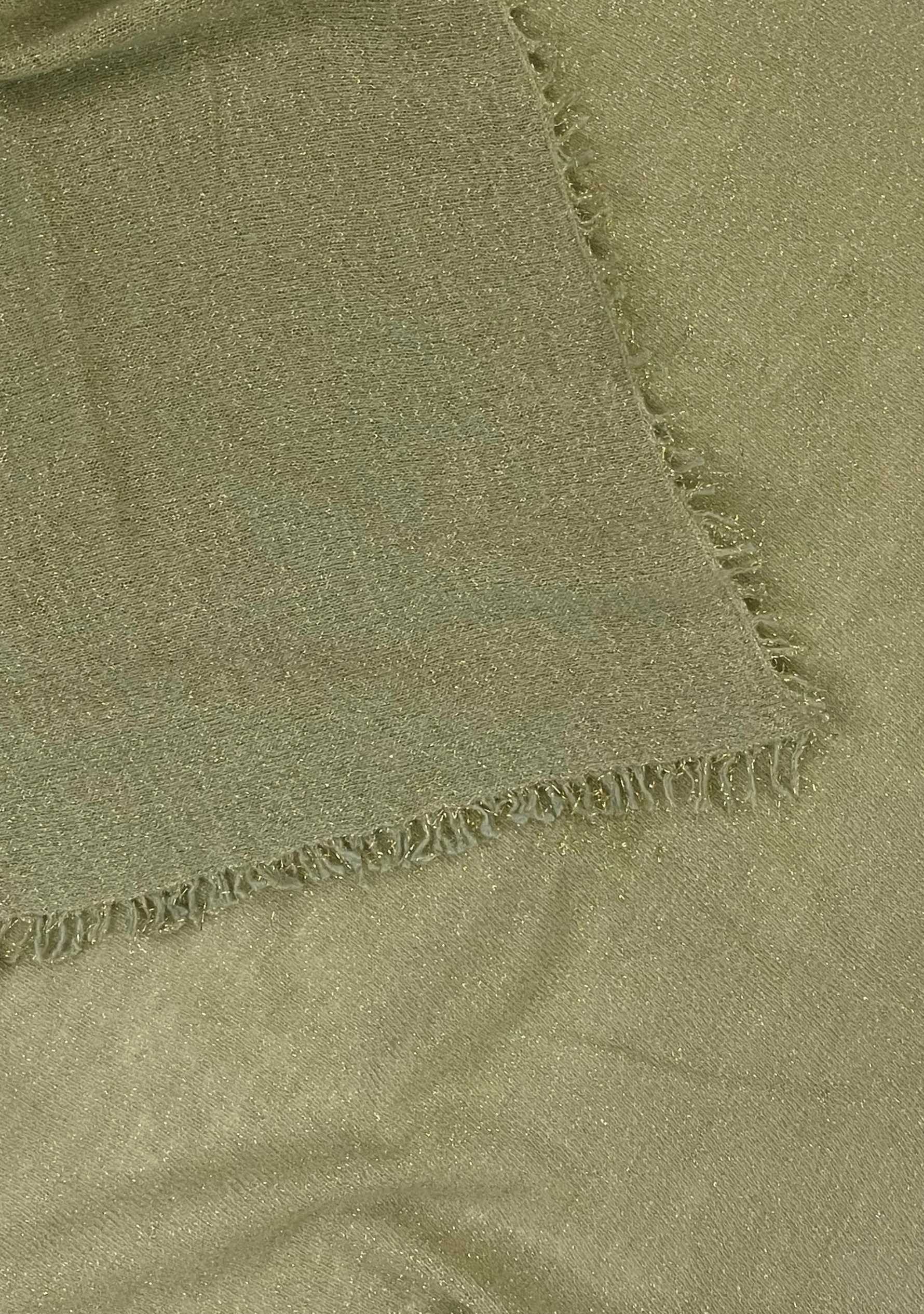 Close-up of a Maneesha Ruia light pistachio knitted fine wool cashmere wrap with gold lurex, luxury designer winter wrap