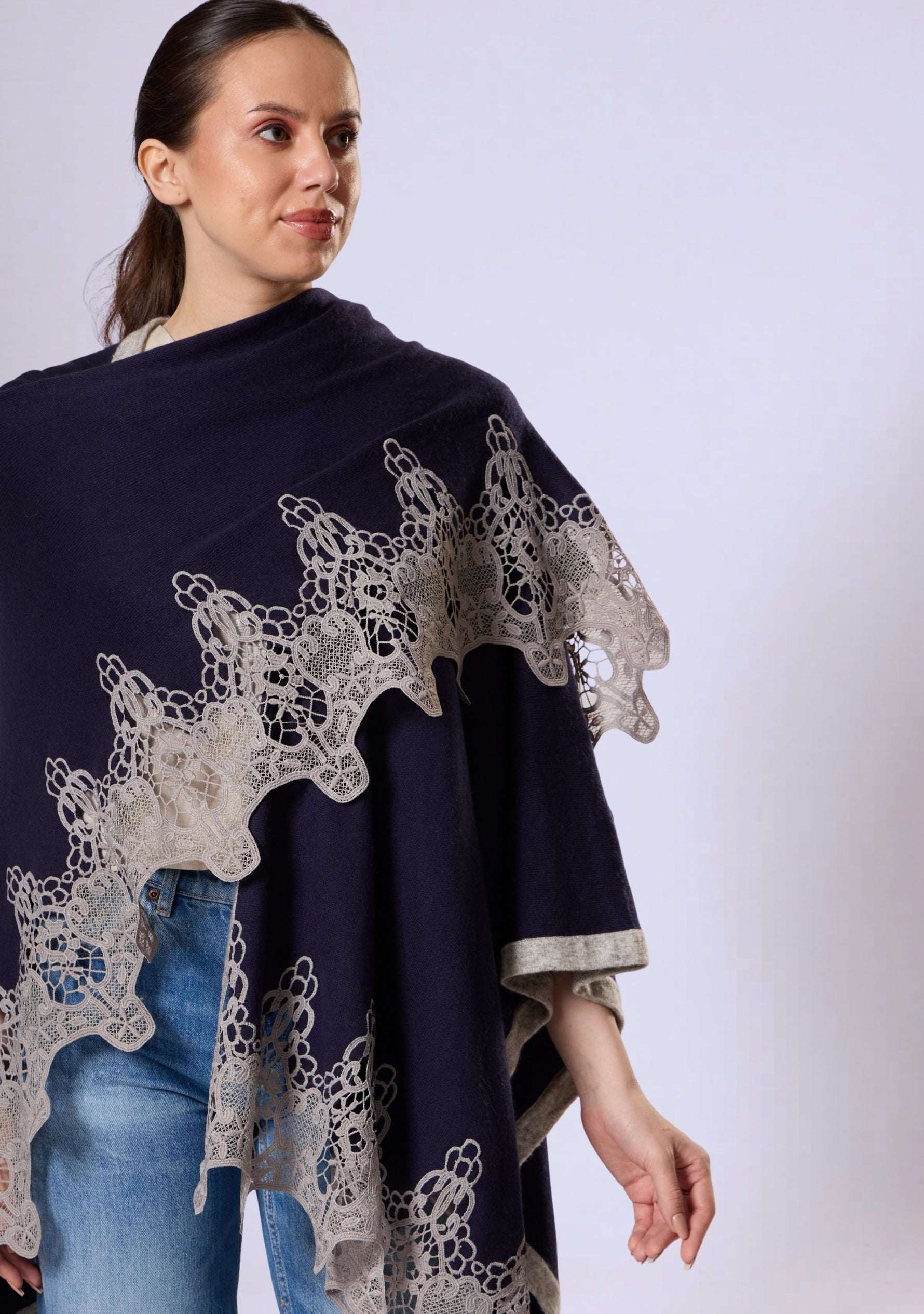 Maneesha Ruia navy blue wool cape with light gray lace styled on female model, elegant winter layer
