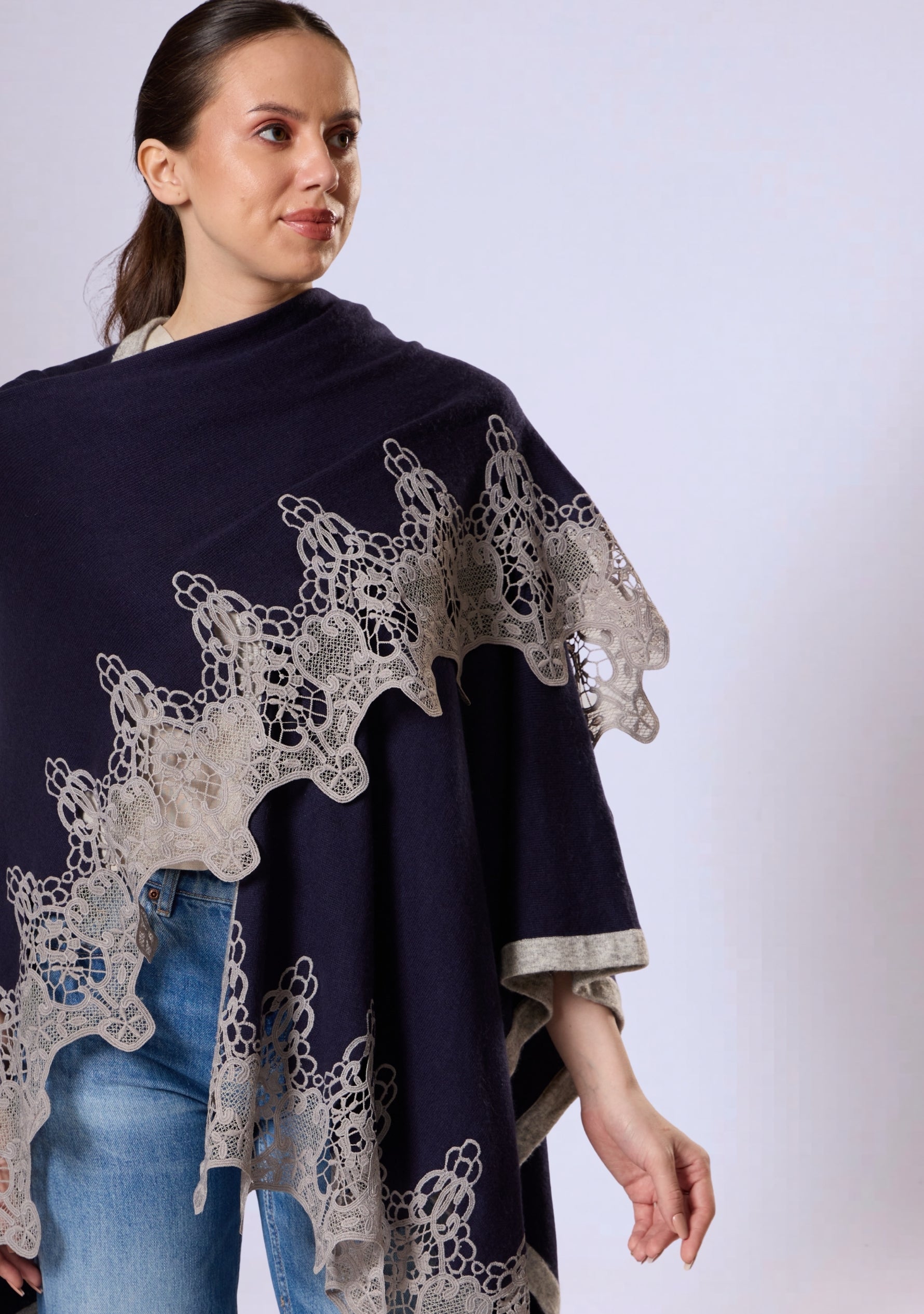 Maneesha Ruia navy blue wool cape with light gray lace styled on female model, elegant winter layer