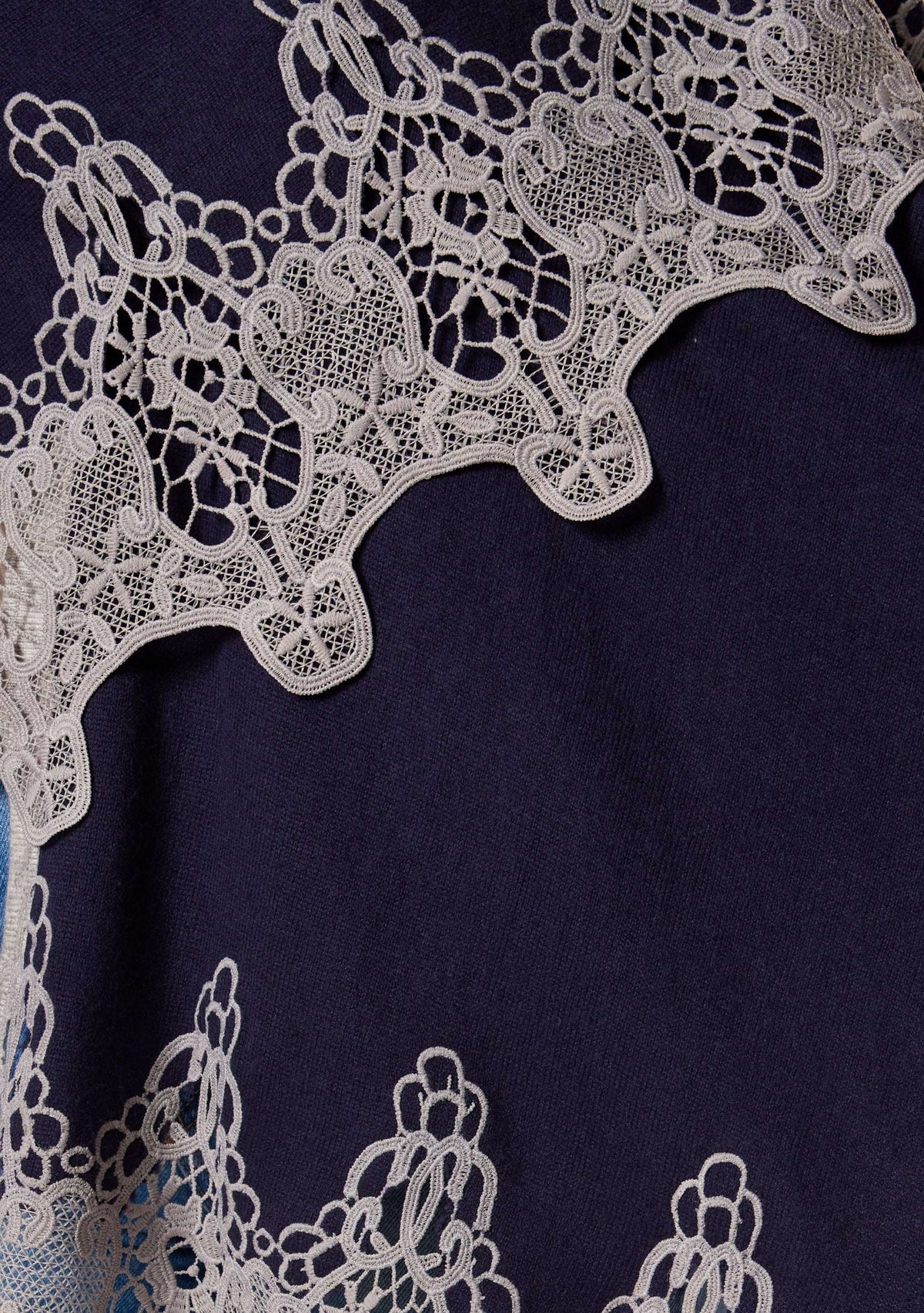 Maneesha Ruia navy blue wool cape with intricate light gray lace border, luxury craftsmanship detail
