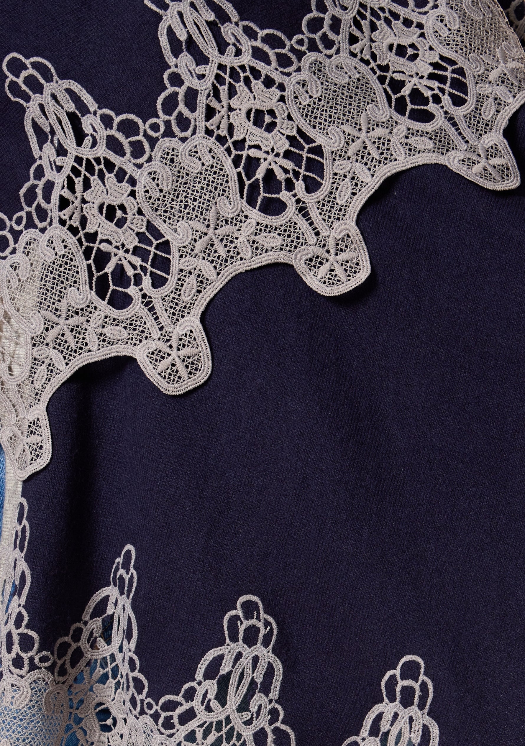 Maneesha Ruia navy blue wool cape with intricate light gray lace border, luxury craftsmanship detail