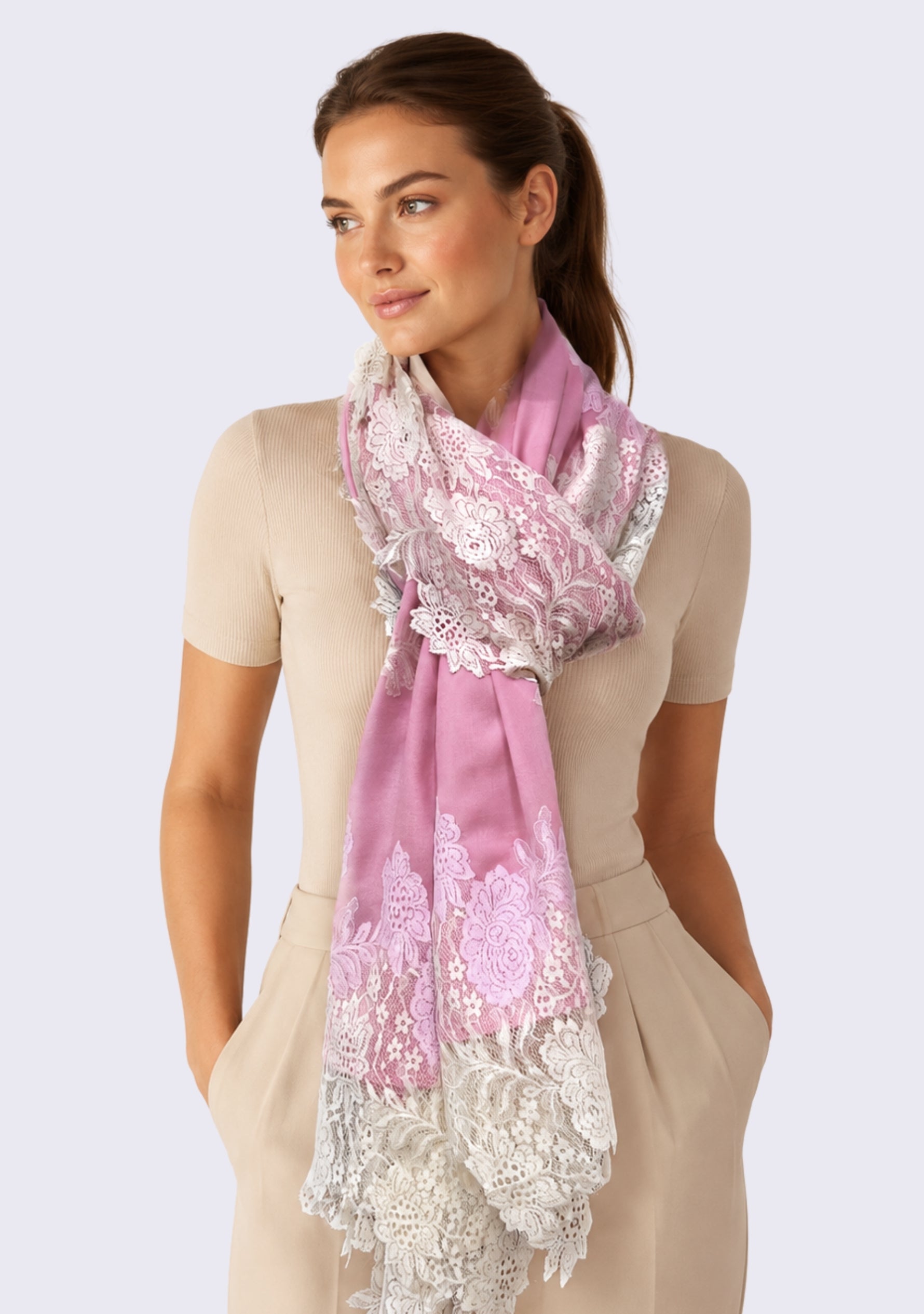 Female model wearing a luxury rose pink wool and silk scarf with handcrafted ivory and soft pink Chantilly floral lace, elegantly wrapped around the neck to showcase its lightweight drape, delicate floral lace, and timeless designer style.