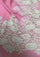 Close-up of a luxury rose pink wool and silk scarf featuring handcrafted ivory and soft pink Chantilly floral lace, highlighting the intricate floral lace craftsmanship, delicate detailing, and premium wool-silk fabric.