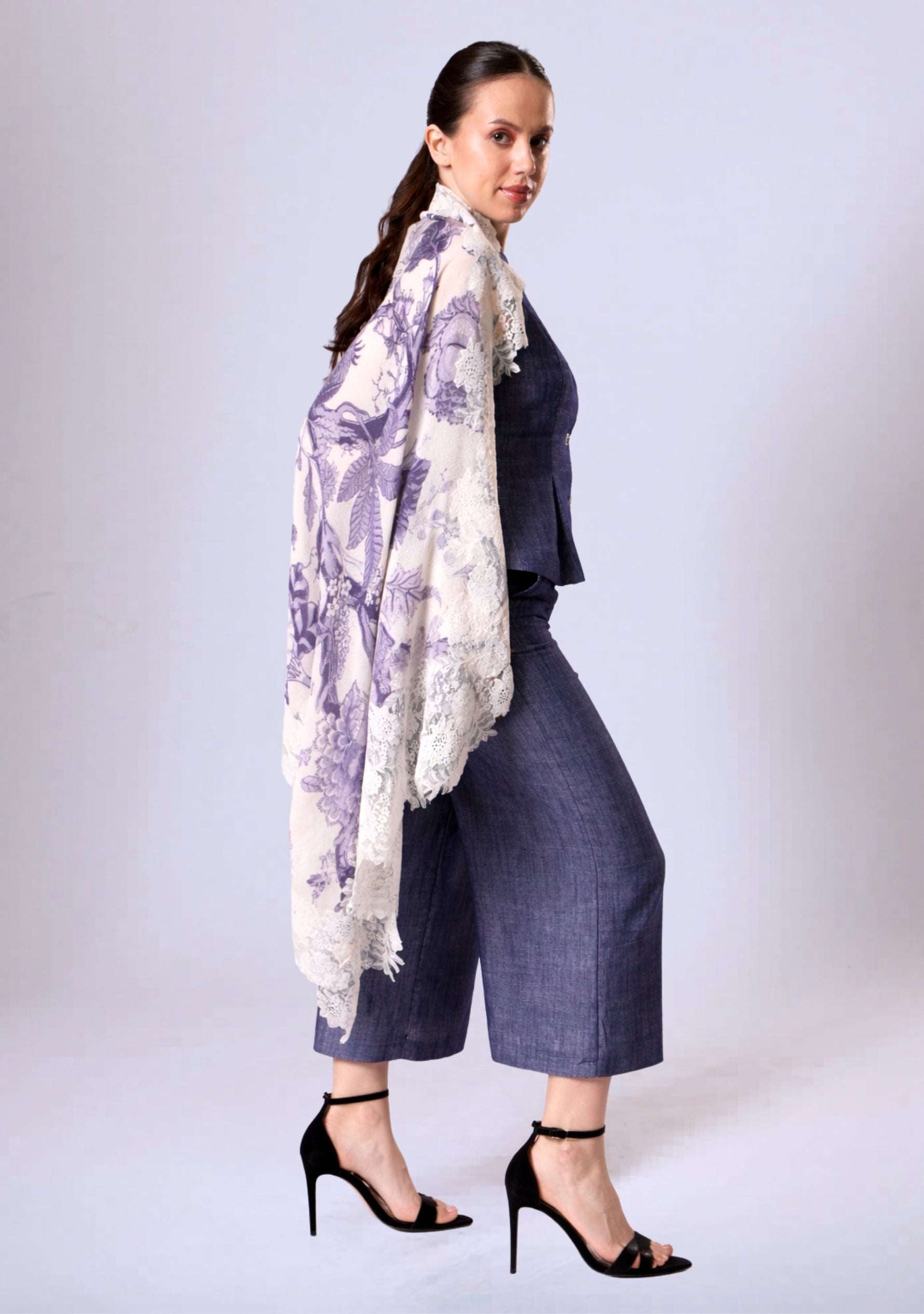 Woman wearing a Maneesha Ruia violet Jacobean-print wool-and-silk scarf with ivory lace, luxury designer floral scarf.